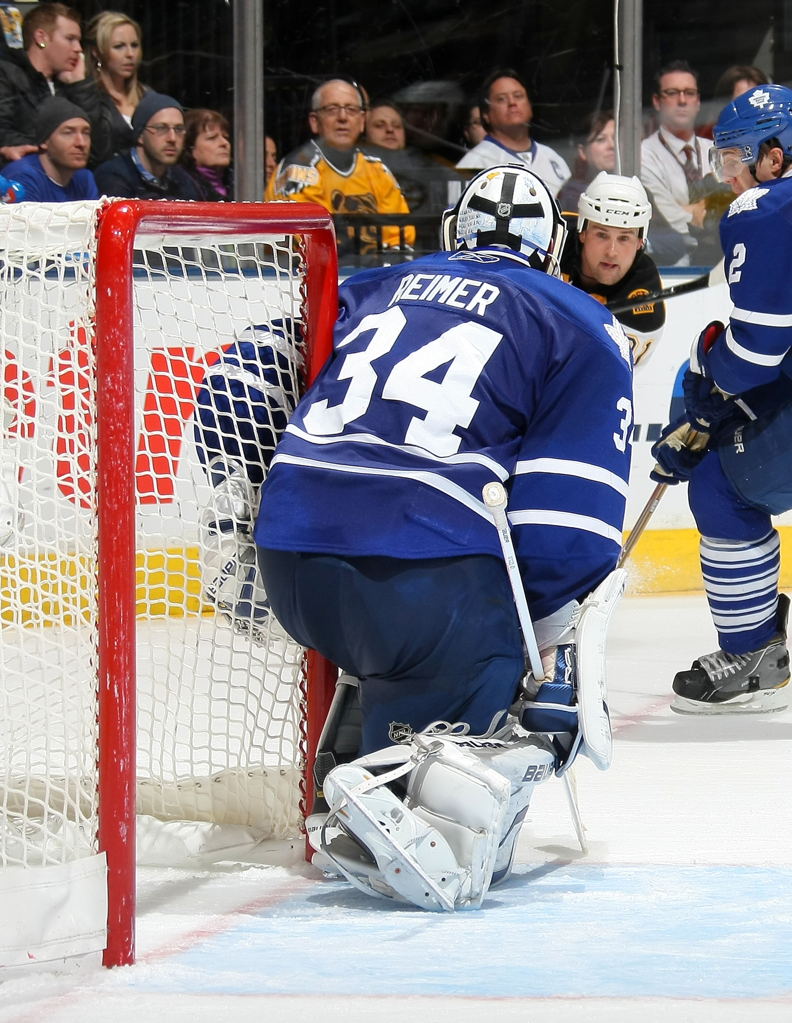 TORONTO,CANADA - JANUARY 3:  Marc Savard #91of the Boston Bruins takes a shot against James Reimer #34 of the Toronto Maple Leafs during their NHL game at Air Canada Centre on January 3, 2011 in Toronto, Ontario, Canada.(Photo By Dave Sandford/Getty Image