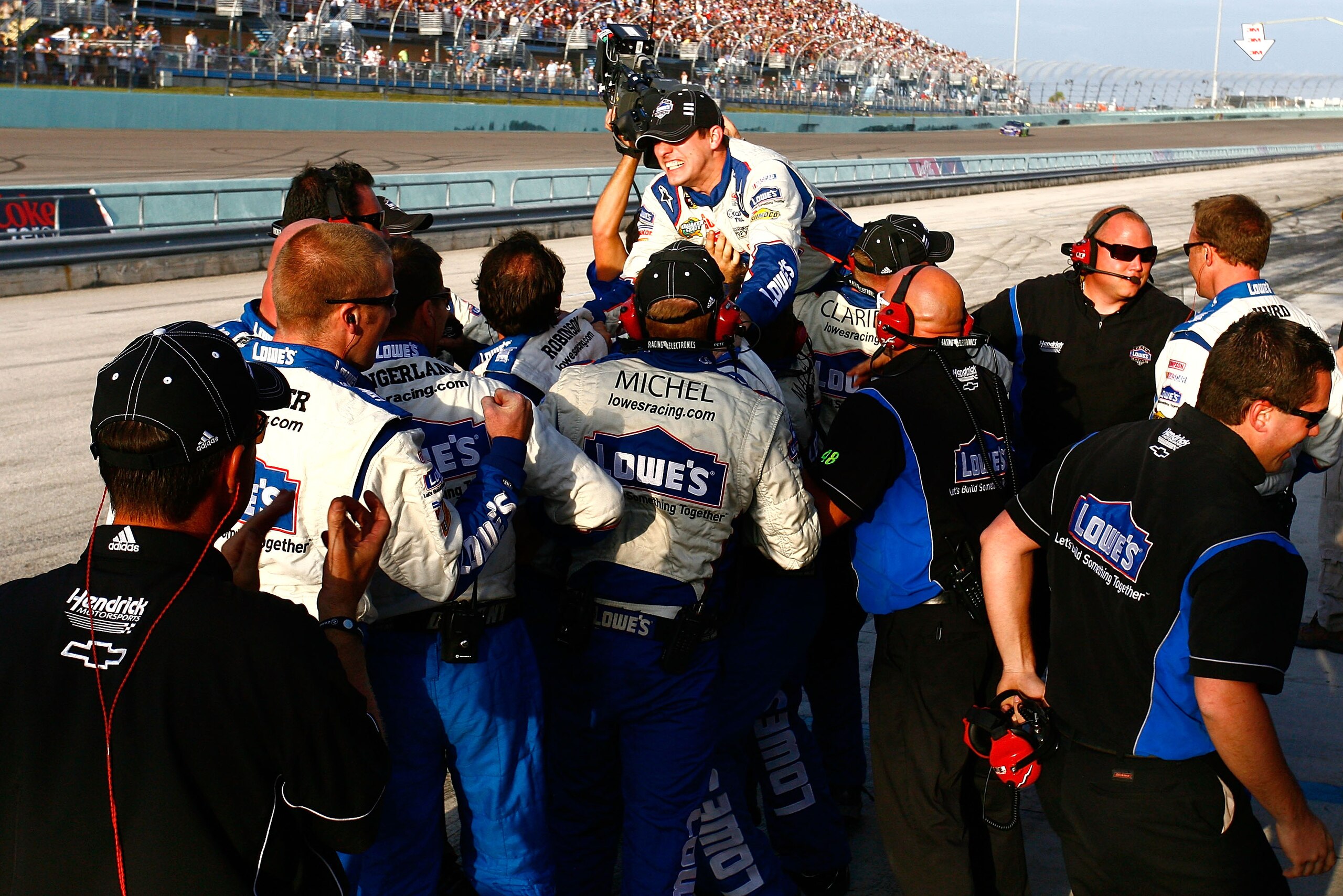 HOMESTEAD, FL - NOVEMBER 21:  Crew members for Jimmie Johnson, driver of the #48 Lowe's Chevrolet, celebrate after finishing in second place in the Ford 400 to clinch a fifth consecutive NASCAR Sprint Cup championship at Homestead-Miami Speedway on Novemb