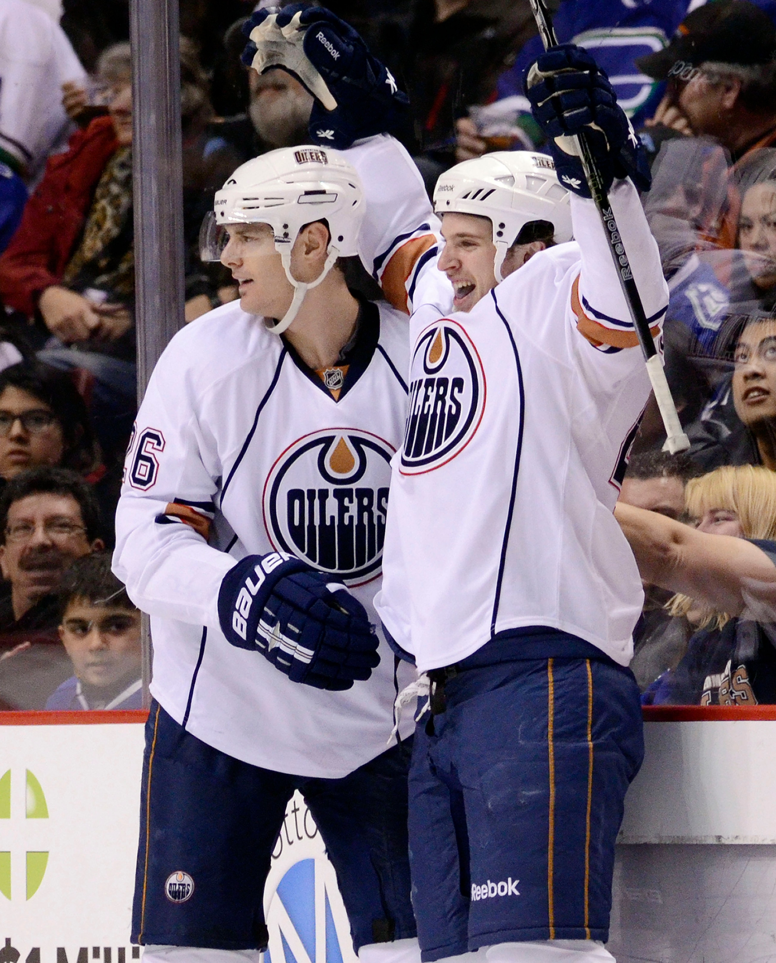 VANCOUVER, CANADA - DECEMBER 26: Ryan O'Marra #42 of the Edmonton Oilers celebrates with Kurtis Foster #26 after scoring his first goal of the season against the Vancouver Canucks during the second period in NHL action on December 26, 2010 at Rogers Arena