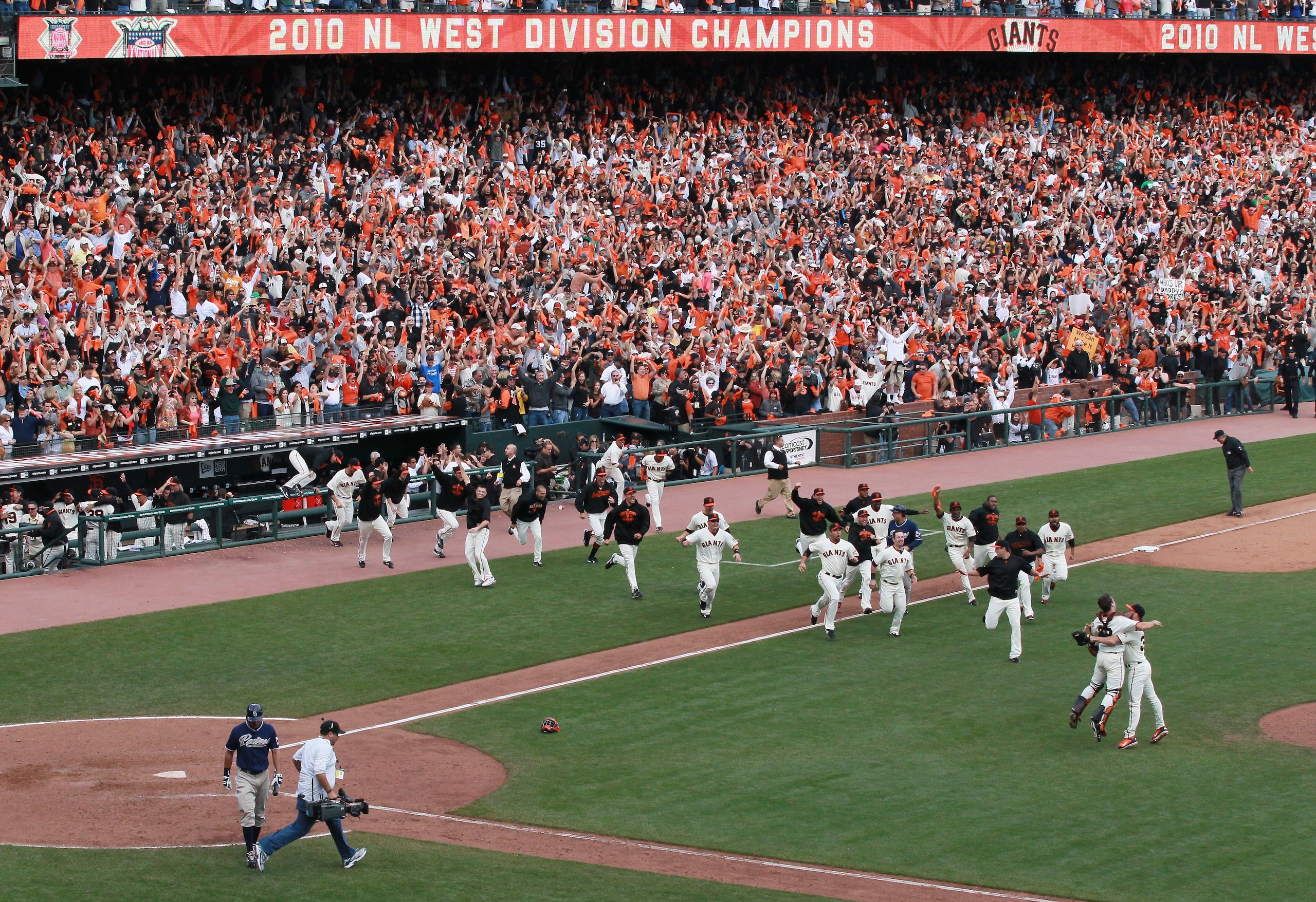 SAN FRANCISCO - OCTOBER 03:  San Francisco Giants players rush the field after clinching the National League West divsion against the San Diego Padres at AT&T Park on October 3, 2010 in San Francisco, California.  The Giants beat the Padres 3-0.  (Photo b