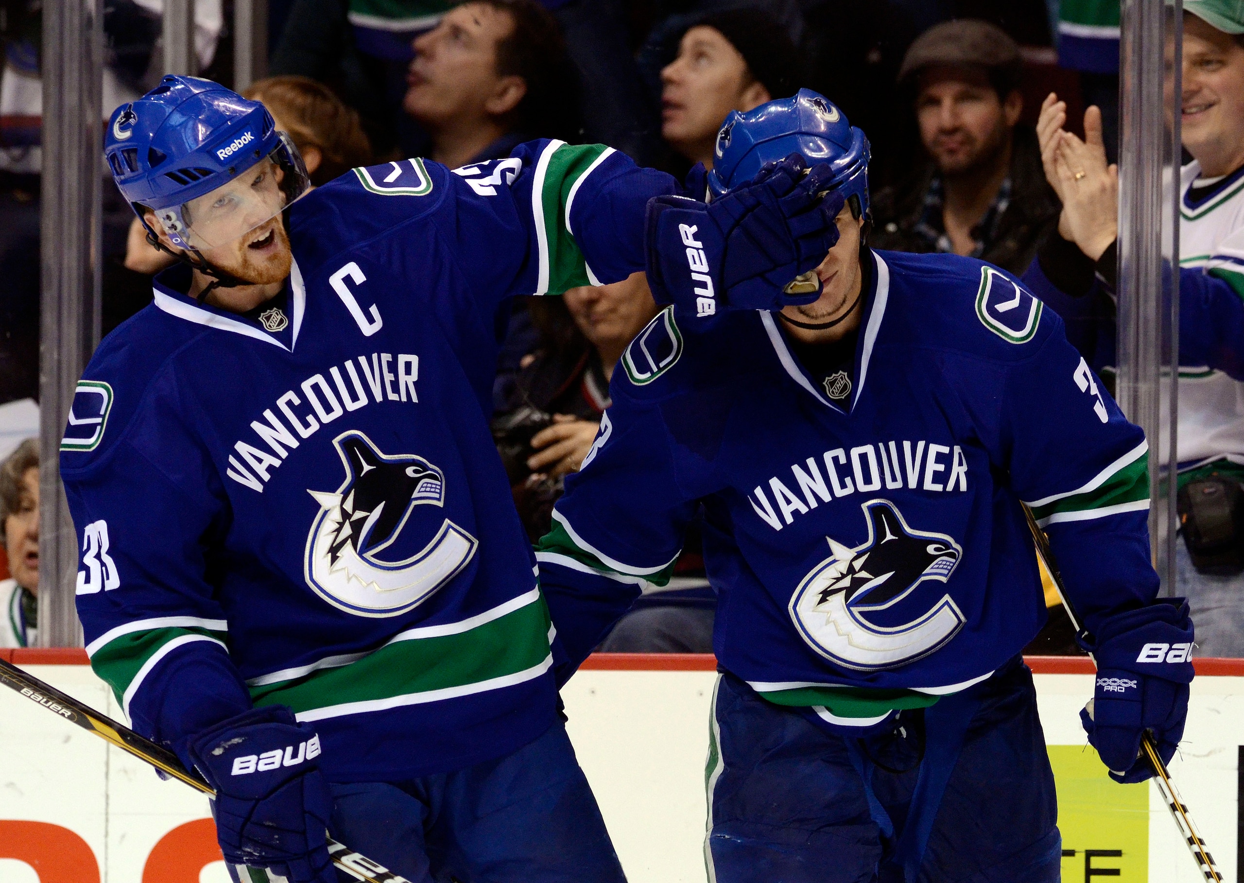 VANCOUVER, CANADA - DECEMBER 26: Kevin Bieksa #3 of the Vancouver Canucks is gets a friendly face wash from Henrik Sedin #33 after scoring what proved to be the game winning goal in a 3-2 win against the Edmonton Oilers during the third period in NHL acti