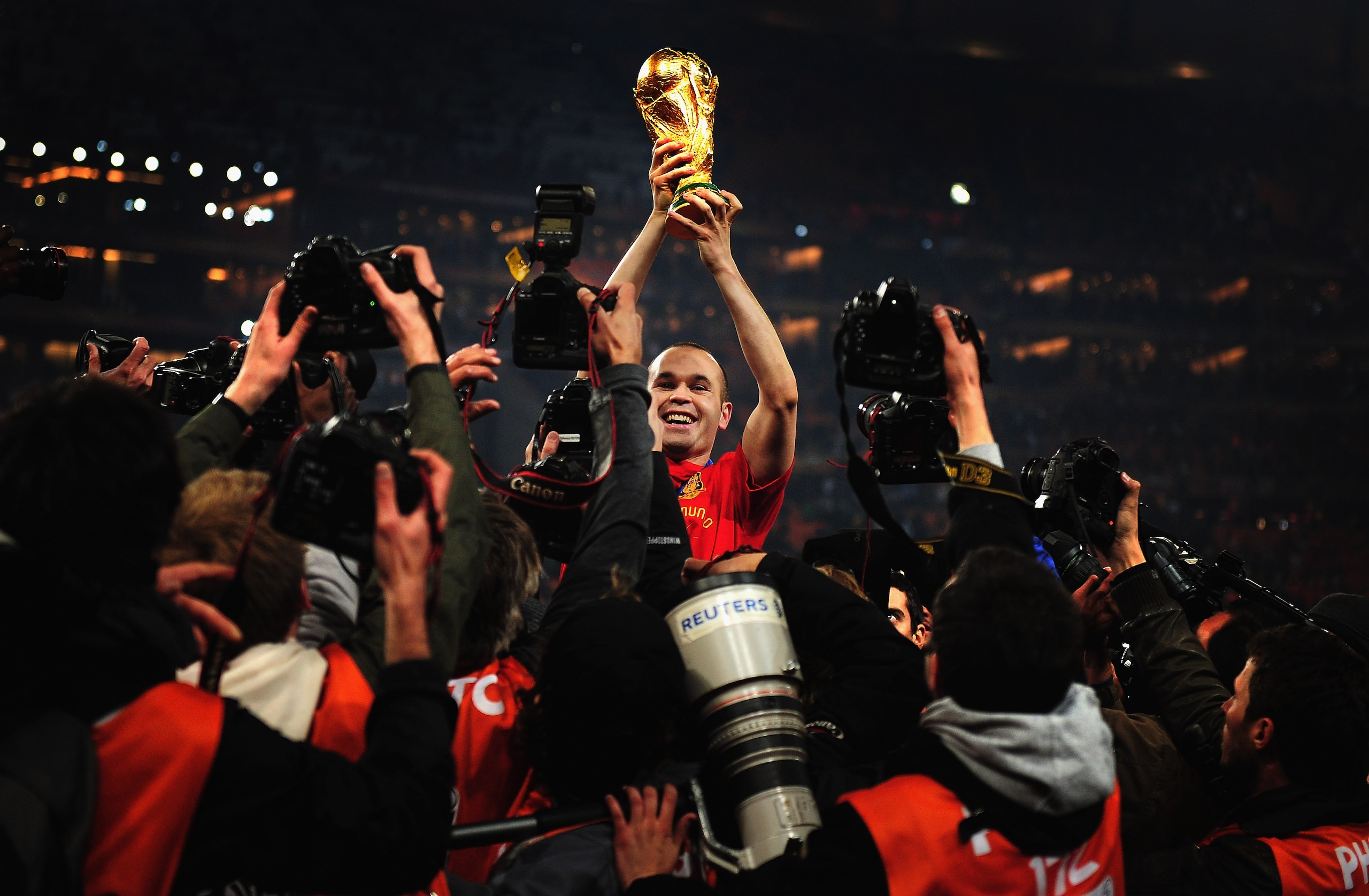 JOHANNESBURG, SOUTH AFRICA - JULY 11:  Andres Iniesta of Spain holds the World Cup trophy aloft after the 2010 FIFA World Cup South Africa Final match between Netherlands and Spain at Soccer City Stadium on July 11, 2010 in Johannesburg, South Africa.  (P