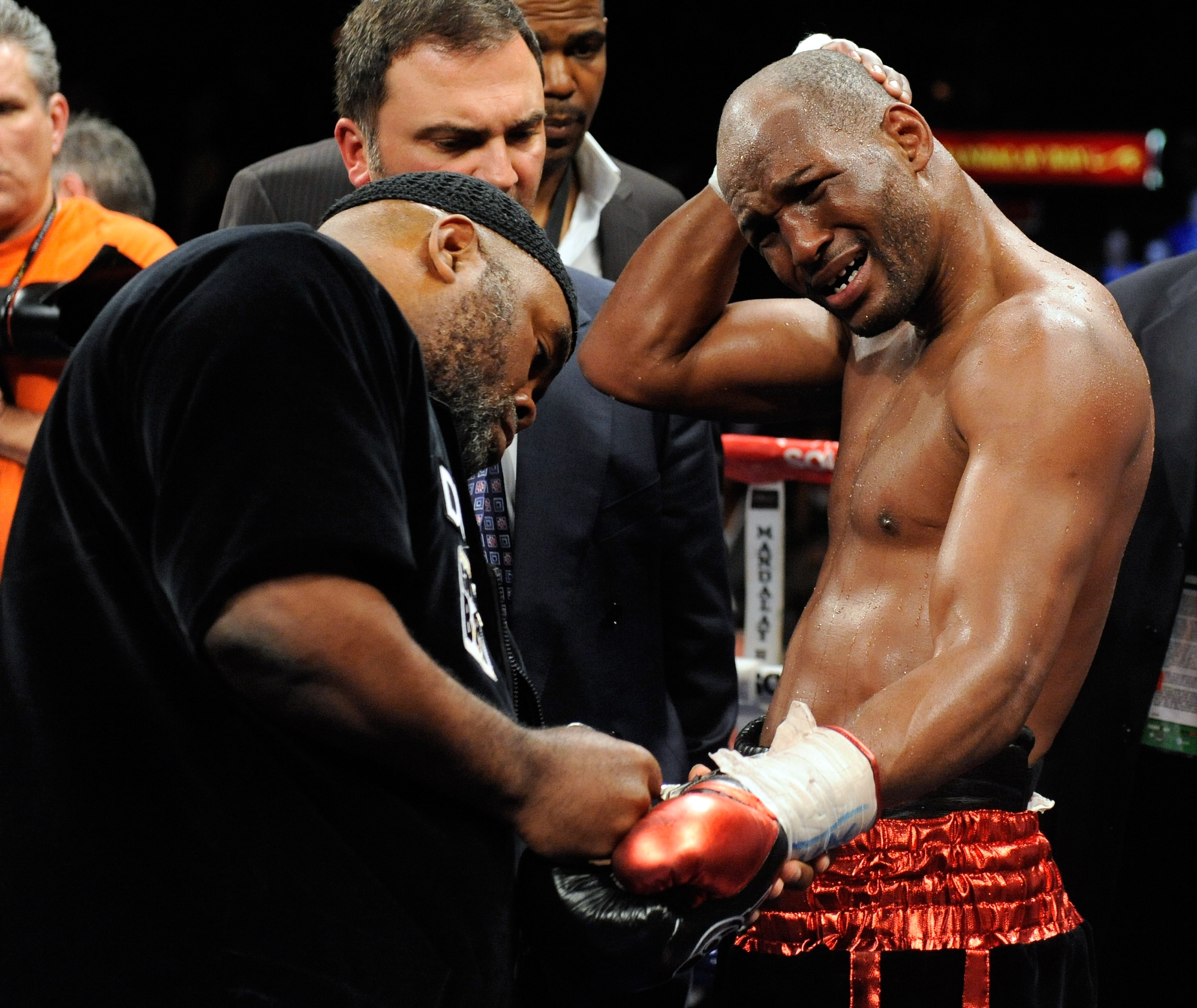 LAS VEGAS - APRIL 03:  Bernard Hopkins (R) holds his head as his trainer Naazim Richardson takes his gloves off after Hopkins defeated Roy Jones Jr. in their light heavyweight bout by unanimous decision at the Mandalay Bay Events Center April 3, 2010 in L