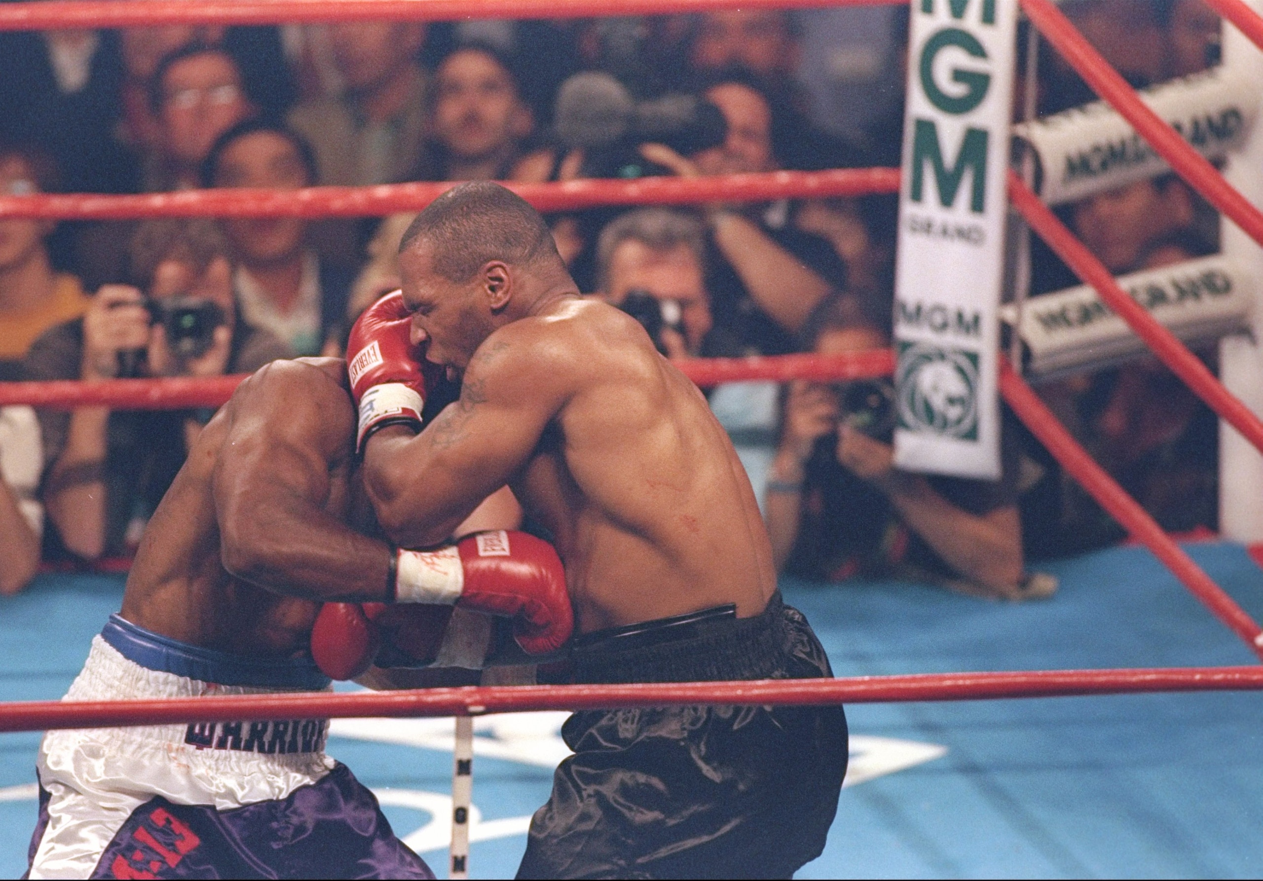 28 Jun 1997:  Evander Holyfield (left) and Mike Tyson grapple during their bout at the MGM Grand Garden in Las Vegas, Nevada.  Holyfield won the fight with a disqualification in the third round. Mandatory Credit: Jamie Squire  /Allsport