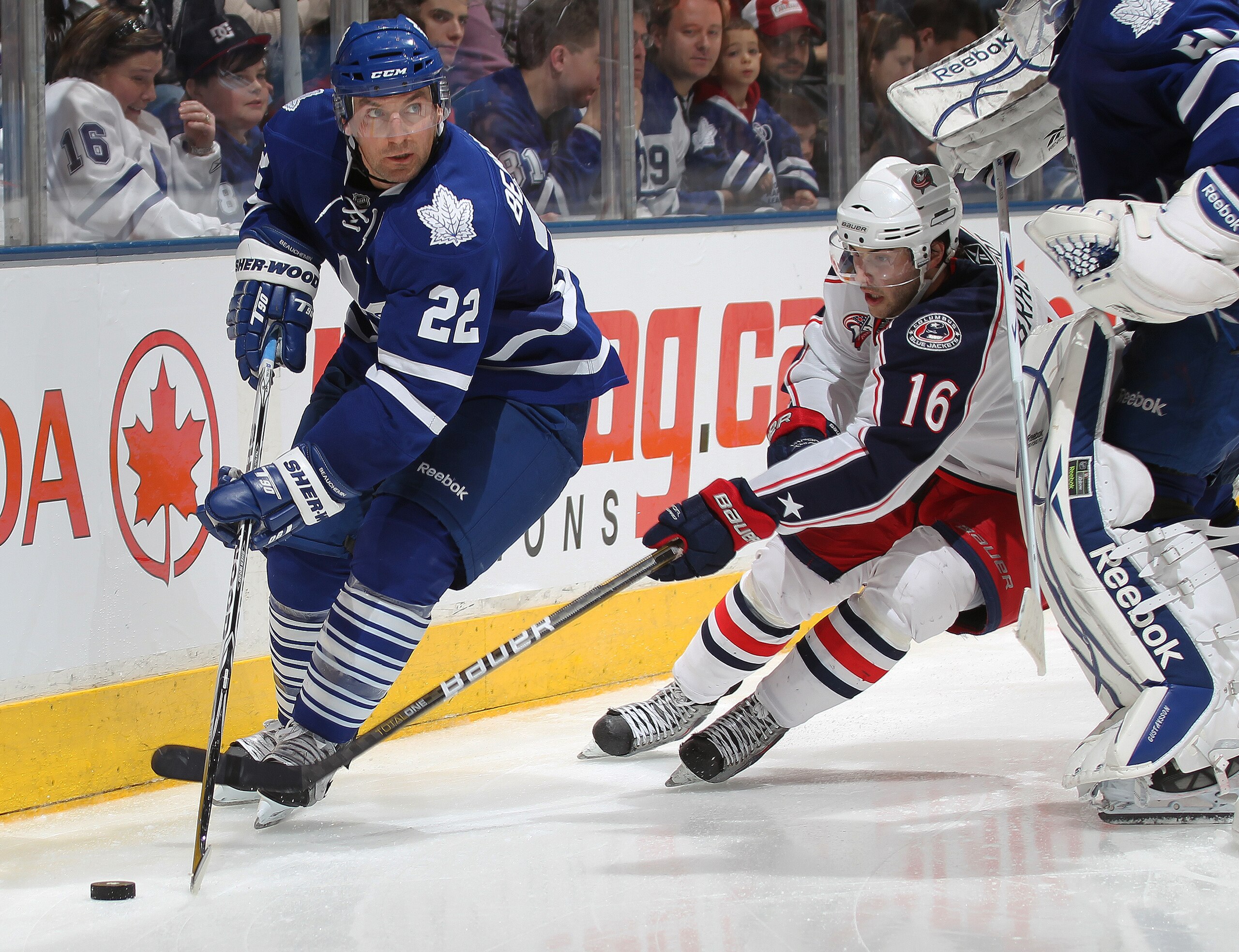 TORONTO, CANADA - DECEMBER 30:  Francois Beauchemin #22 of the Toronto Maple Leafs tries to elude the checking of Derek Brassard #16 of the Columbus Blue Jackets in a game on December 30, 2010 at the Air Canada Centre in Toronto, Canada. The Blue Jackets