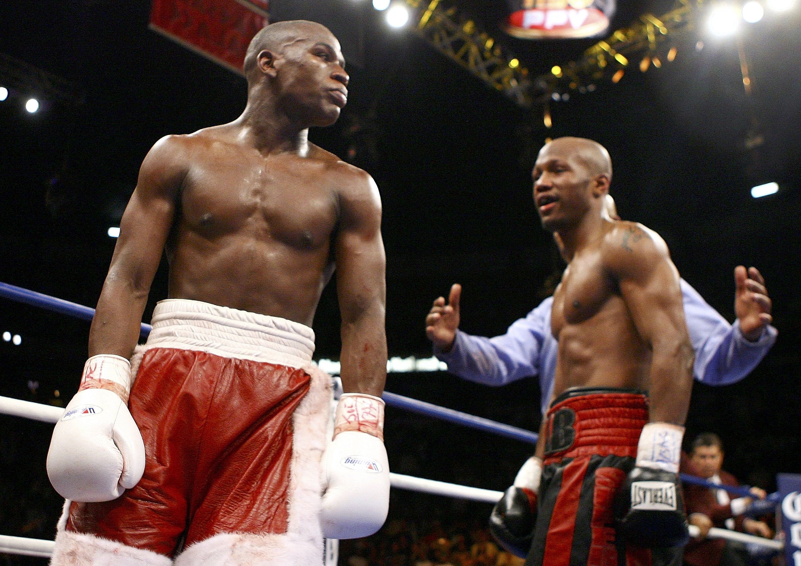 LAS VEGAS - APRIL 08:  (L-R)  Floyd Mayweather walks away at the end of the fight against Zab Judah with a right during the Welterweight Championship fight at Thomas & Mack Arena on April 8, 2006 in Las Vegas, Nevada. Mayweather was named winner against J