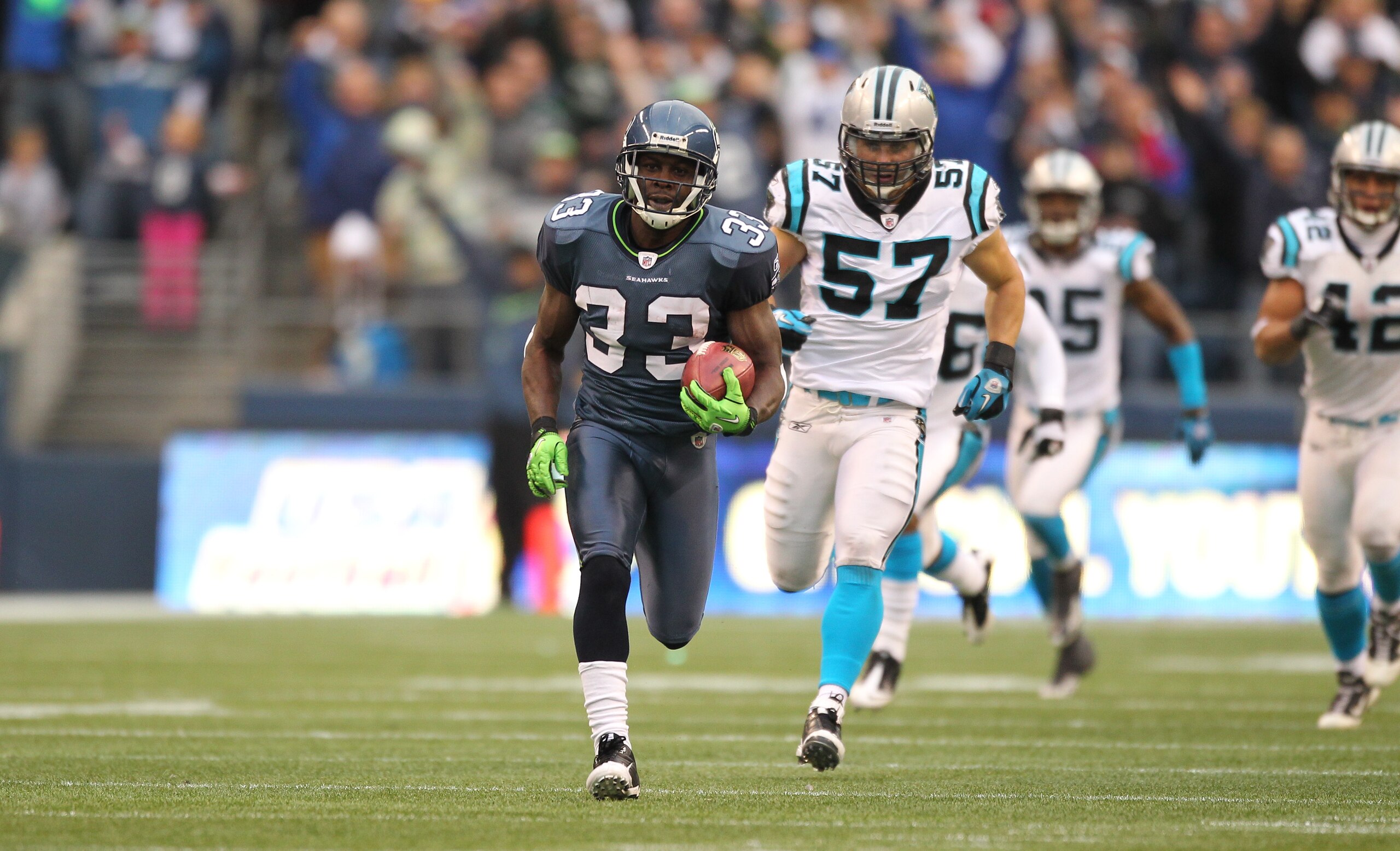 SEATTLE - DECEMBER 05:  Running back Leon Washington #33 of the Seattle Seahawks returns a punt for 84 yards against the Carolina Panthers at Qwest Field on December 5, 2010 in Seattle, Washington. Washington was down at the 2 yard line on the play, and t