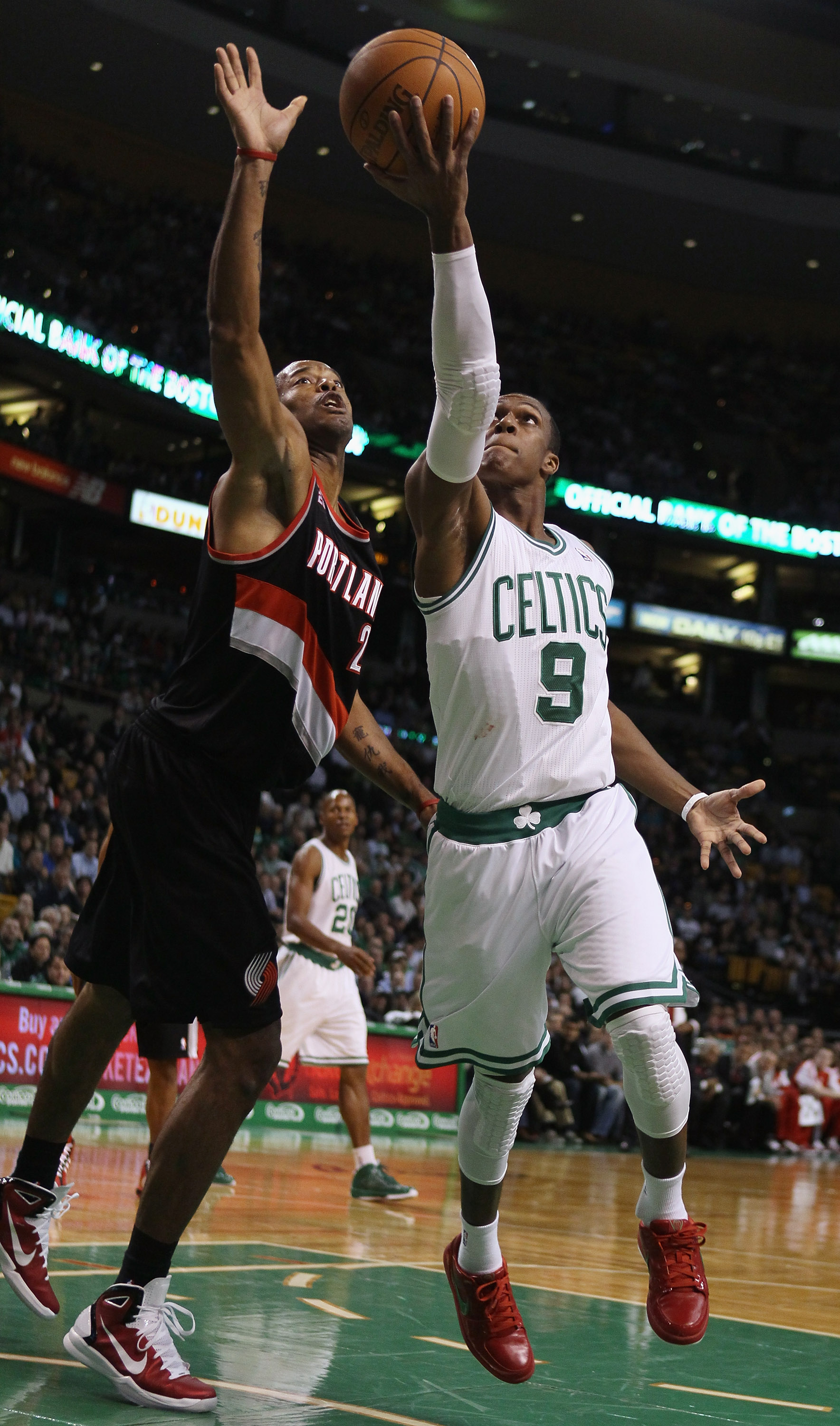 BOSTON - DECEMBER 01:  Rajon Rondo #9 of the Boston Celtics heads for the basket as Marcus Camby #23 of the Portland Trailblazers defends on December 1, 2010 at the TD Garden in Boston, Massachusetts.  NOTE TO USER: User expressly acknowledges and agrees