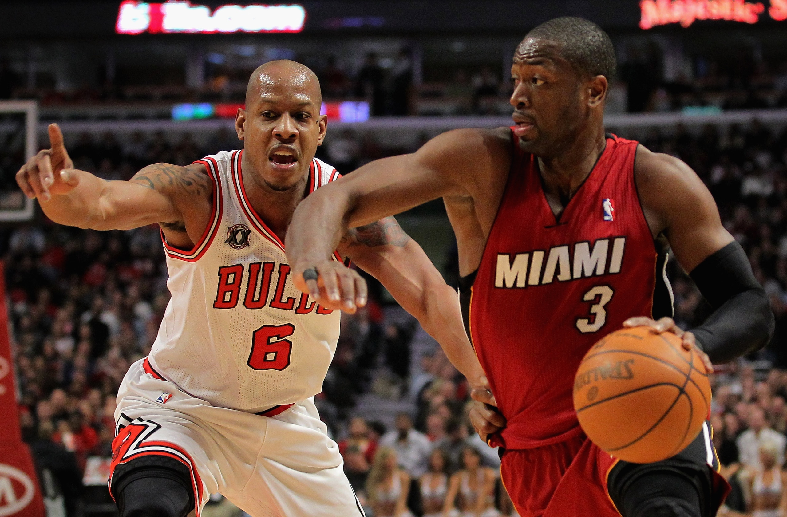 CHICAGO, IL - JANUARY 15:  Dwayne Wade #3 of the Miami Heat drives to the basket against Keith Bogans #6 of the Chicago Bulls at the United Center on January 15, 2011 in Chicago, Illinois. NOTE TO USER: User expressly acknowledges and agrees that, by down