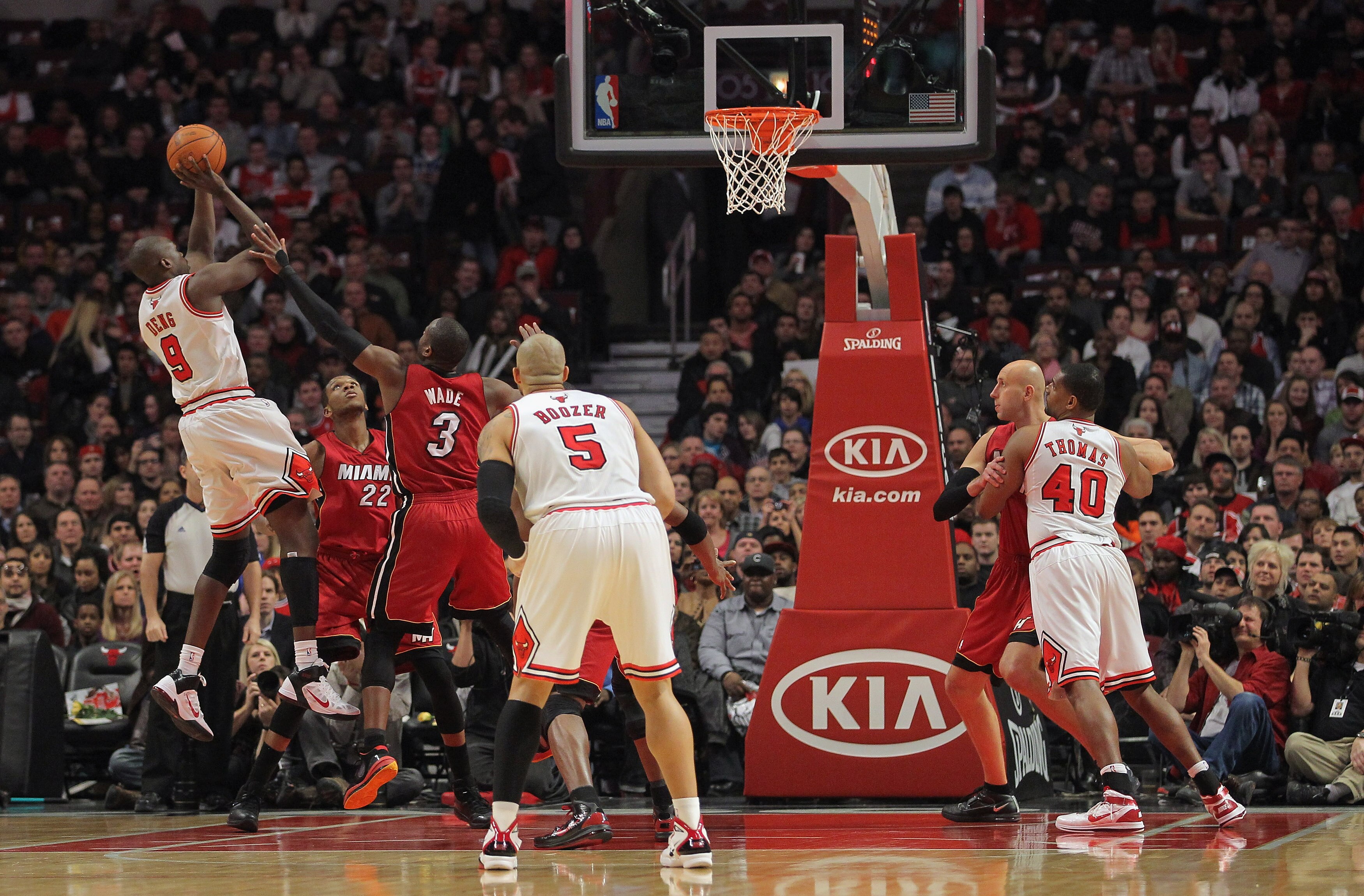 CHICAGO, IL - JANUARY 15:  Luol Deng #9 of the Chicago Bulls takes a shot over Dwyane Wade #3 of the Miami Heat at the United Center on January 15, 2011 in Chicago, Illinois. NOTE TO USER: User expressly acknowledges and agrees that, by downloading and or