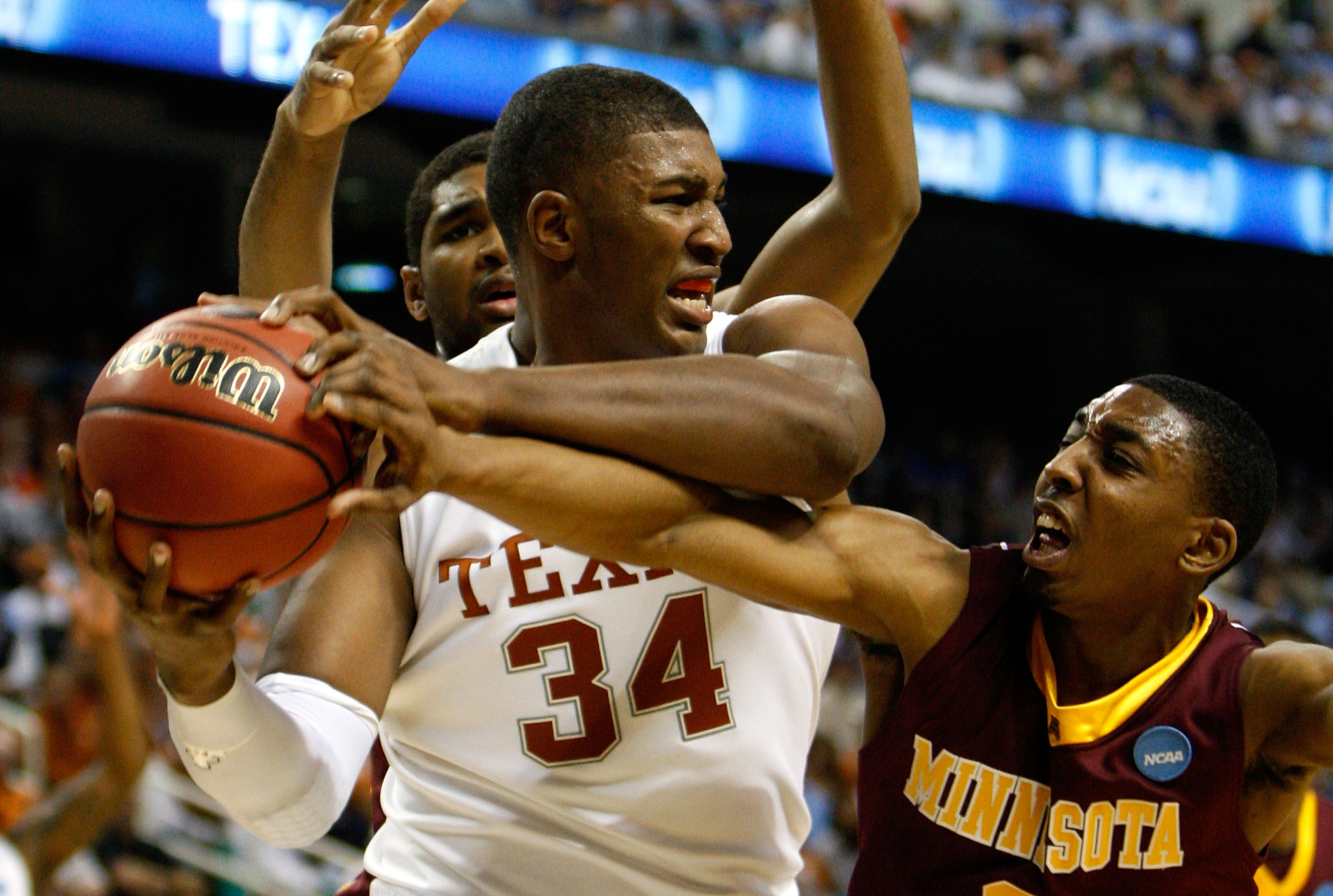 GREENSBORO, NC - MARCH 19:  Al Nolen #0 of the Minnesota Golden Gophers reaches in for a steal against Dexter Pittman #34 of the Texas Longhorns during the first round of the NCAA Division I Men's Basketball Tournament at the Greensboro Coliseum on March