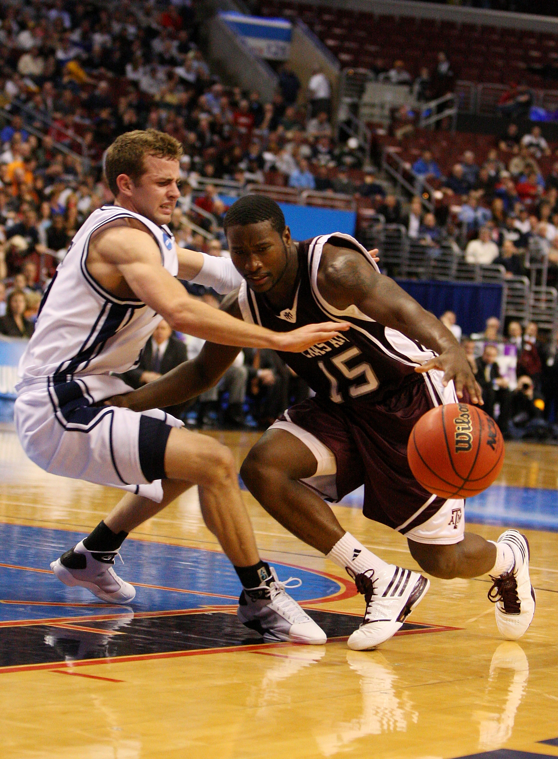PHILADELPHIA - MARCH 19:  Donald Sloan #15 of the Texas A&M Aggies drives against Jackson Emery #4 of the Brigham Young Cougars during the first round of the NCAA Division I Men's Basketball Tournament at the Wachovia Center on March 19, 2009 in Philadelp