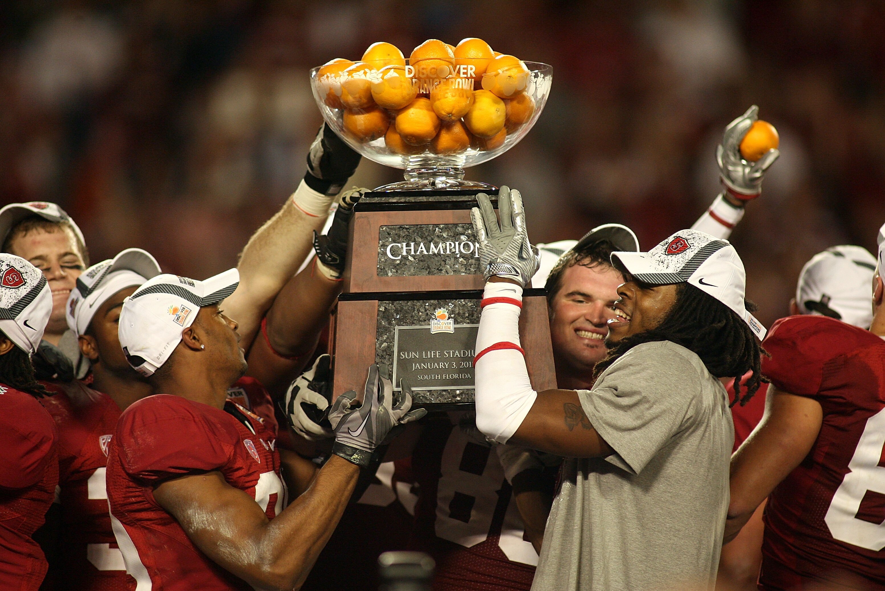 MIAMI, FL - JANUARY 03:  Players from the Stanford Cardinal hold up the Orange Bowl Champion trophy after they won 40-12 against the Virginai Tech Hokies during the 2011 Discover Orange Bowl at Sun Life Stadium on January 3, 2011 in Miami, Florida.  (Phot