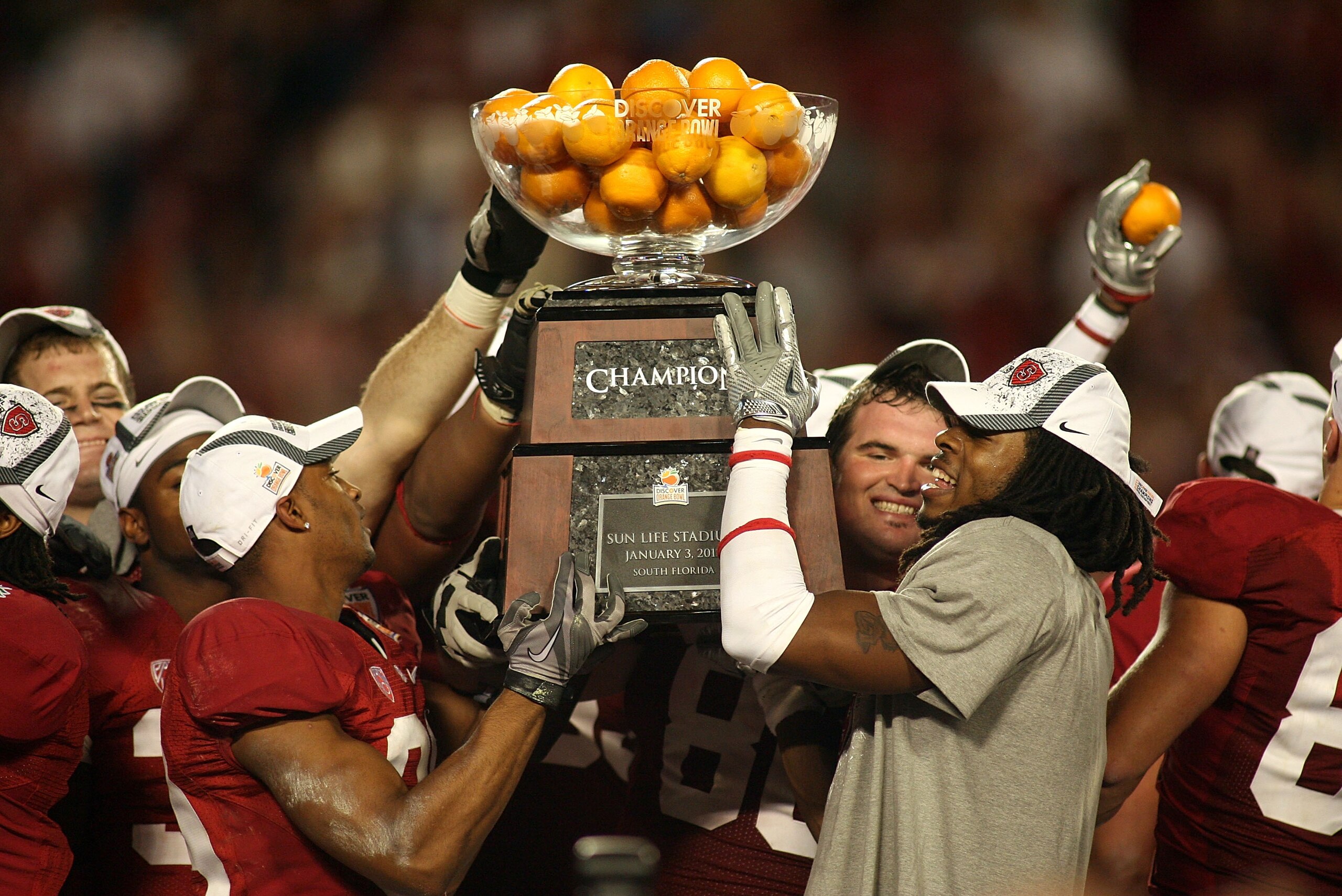 MIAMI, FL - JANUARY 03: Players from the Stanford Cardinal hold up the Orange Bowl Champion trophy after they won 40-12 against the Virginai Tech Hokies during the 2011 Discover Orange Bowl at Sun Life Stadium on January 3, 2011 in Miami, Florida. (Phot MIAMI, FL - JANUARY 03: Players from the Stanford Cardinal hold up the Orange Bowl Champion trophy after they won 40-12 against the Virginai Tech Hokies during the 2011 Discover Orange Bowl at Sun Life Stadium on January 3, 2011 in Miami, Florida. (Phot