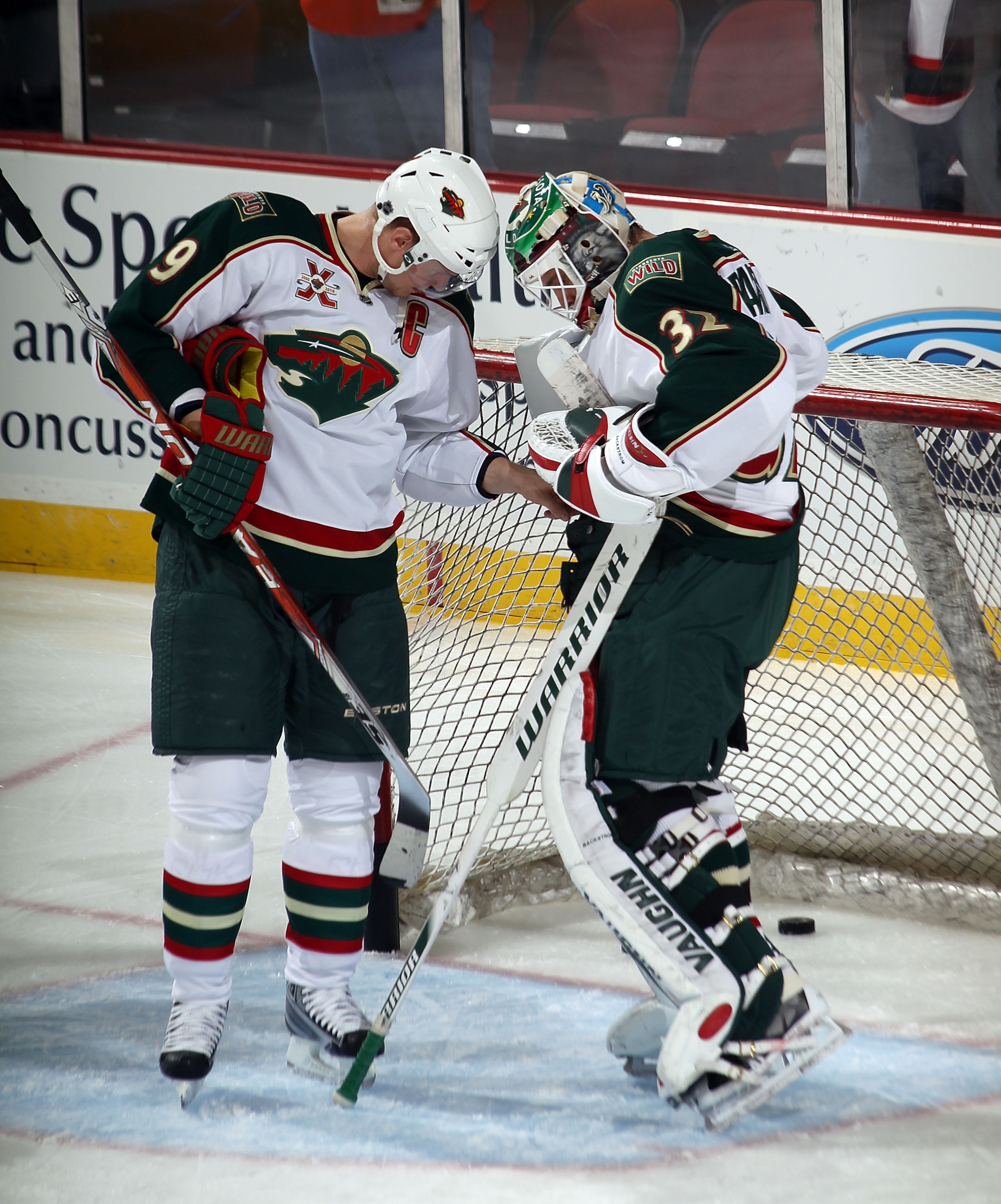 NEWARK, NJ - JANUARY 04: Mikko Koivu #9 of the Minnesota Wild searches for a missing puck in the pads of Niklas Backstrom #32 during warmups prior to the game against the New Jersey Devils at the Prudential Center on January 4, 2011 in Newark, New Jersey.