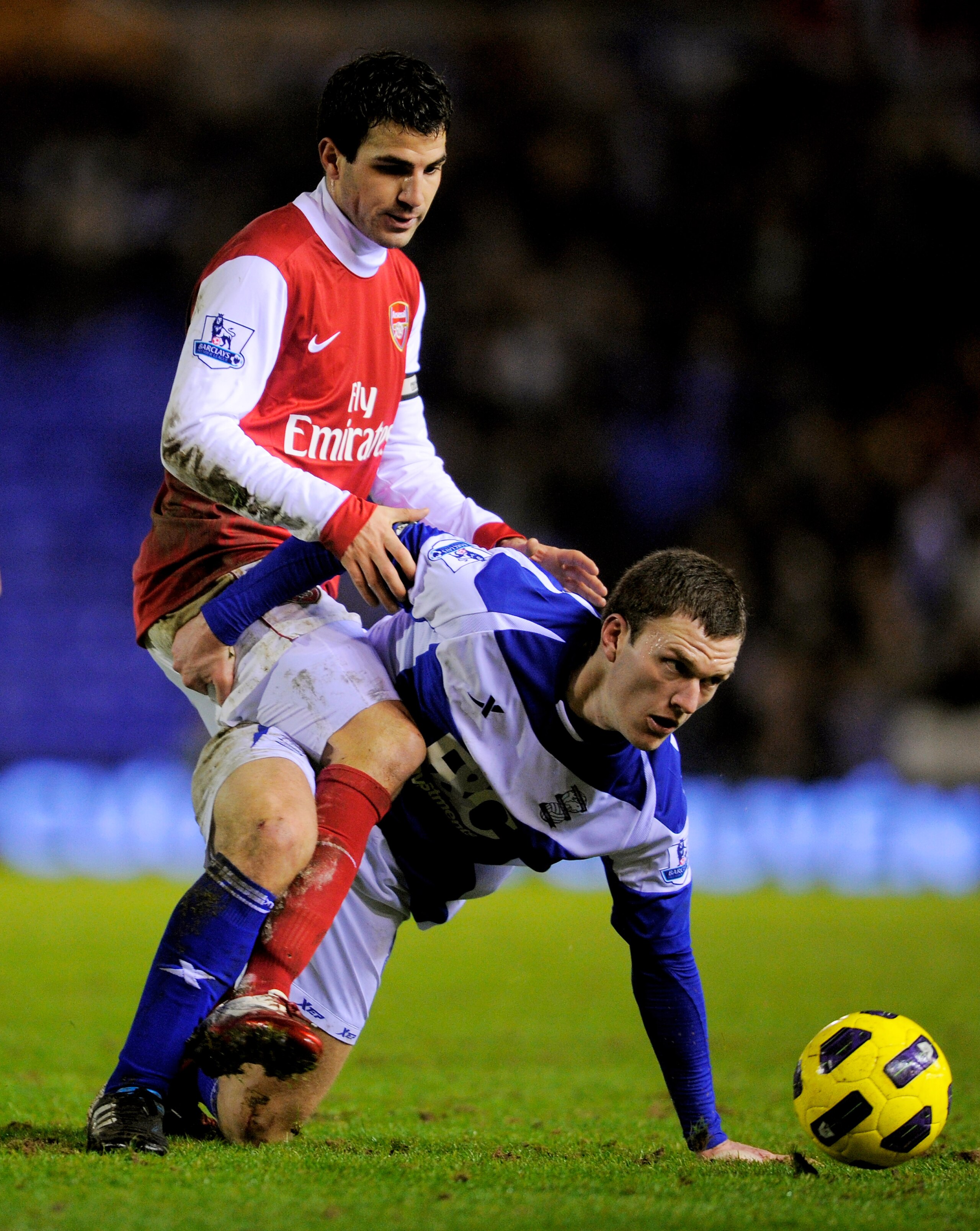 BIRMINGHAM, ENGLAND - JANUARY 01:  Cesc Fabregas of Arsenal is tackled by Craig Gardner of Birmingham during the Barclays Premier Leaue match between Birmingham City and Arsenal at St. Andrews on January 1, 2011 in Birmingham, England.  (Photo by Michael