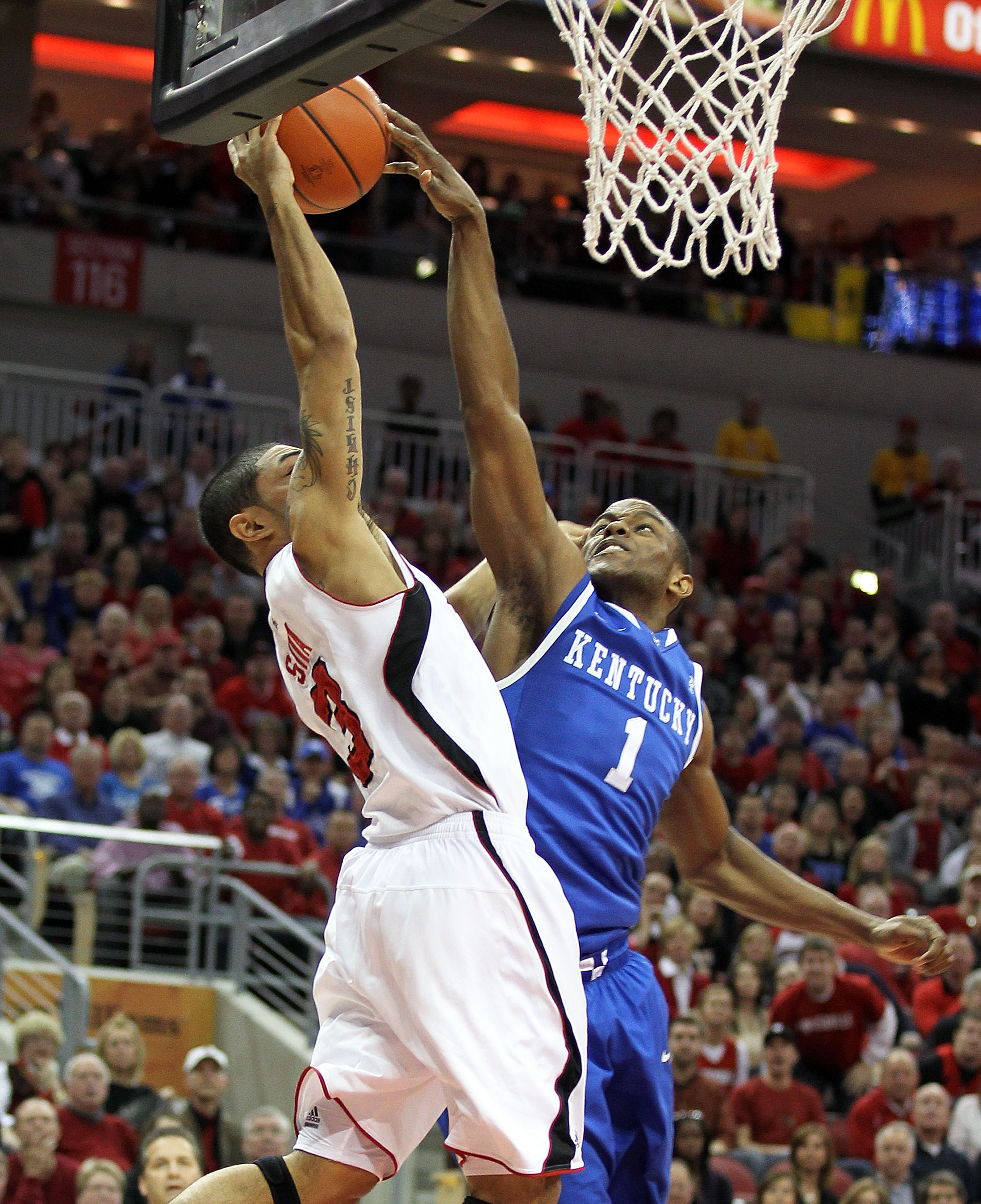 LOUISVILLE, KY - DECEMBER 31:  Peyton Siva #3 of the Louisville Cardinals has his shot blocked by Darius Miller #1 of the Kentucky Wildcats during the game at the KFC Yum! Center on December 31, 2010 in Louisville, Kentucky. Kentucky won 78-63.  (Photo by