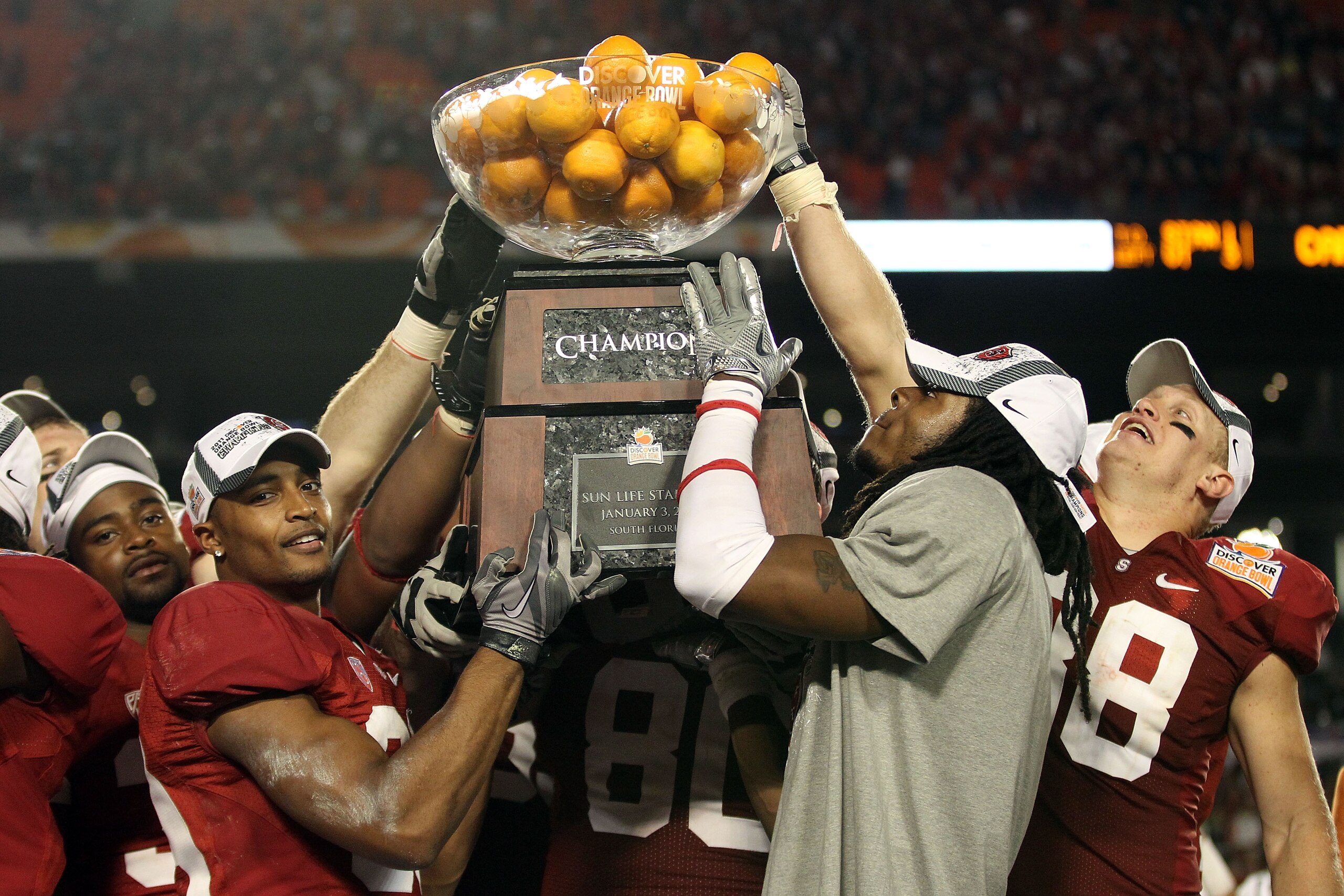 MIAMI, FL - JANUARY 03: Players from the Stanford Cardinal hold up the Orange Bowl Champion trophy after they won 40-12 against the Virginia Tech Hokies during the 2011 Discover Orange Bowl at Sun Life Stadium on January 3, 2011 in Miami, Florida. (Photo MIAMI, FL - JANUARY 03: Players from the Stanford Cardinal hold up the Orange Bowl Champion trophy after they won 40-12 against the Virginia Tech Hokies during the 2011 Discover Orange Bowl at Sun Life Stadium on January 3, 2011 in Miami, Florida. (Photo