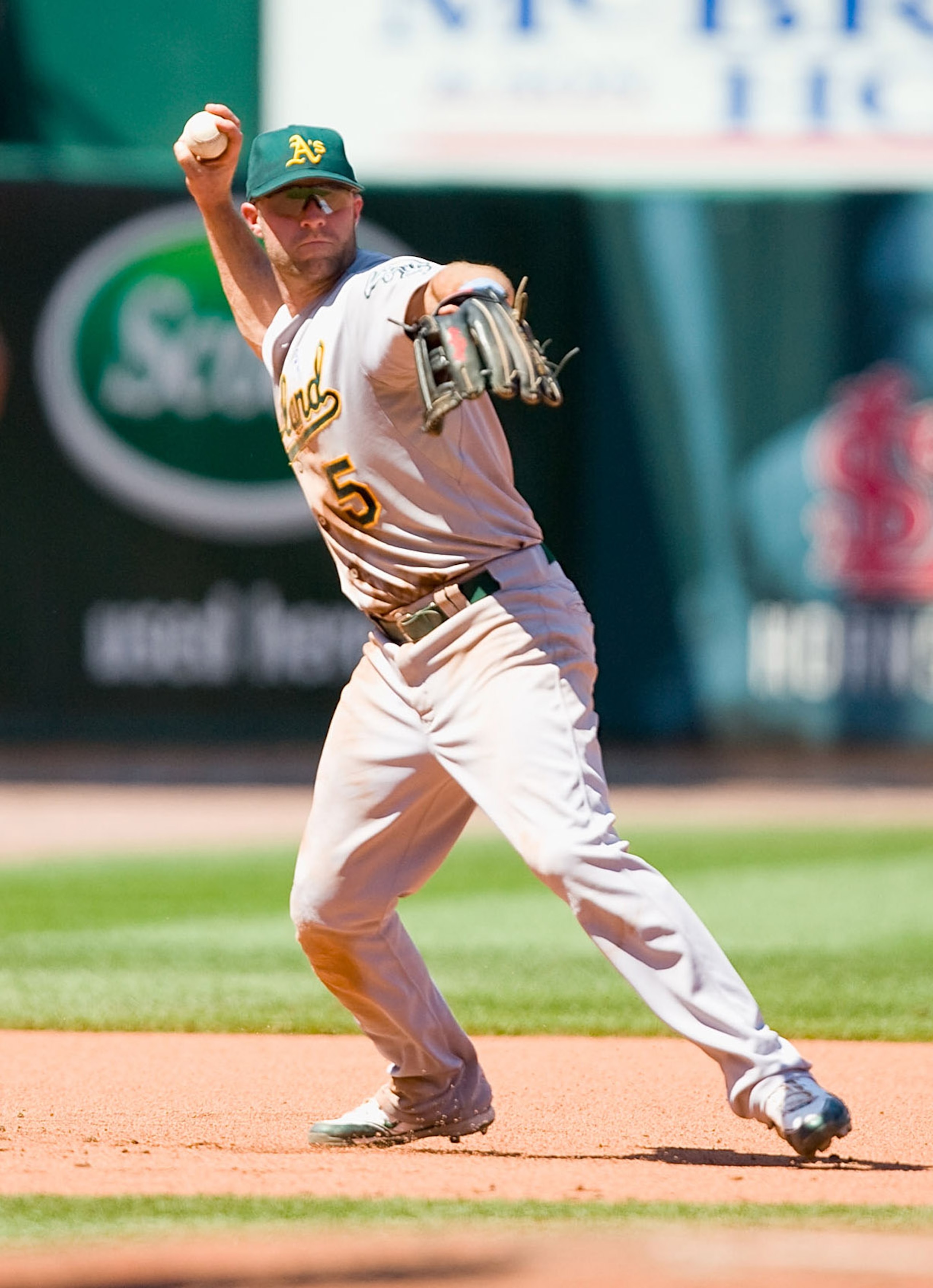 ST. LOUIS - JUNE 20: Kevin Kouzmanoff #5 of the Oakland Athletics throws to first base against the St. Louis Cardinals at Busch Stadium on June 20, 2010 in St. Louis, Missouri.  (Photo by Dilip Vishwanat/Getty Images)