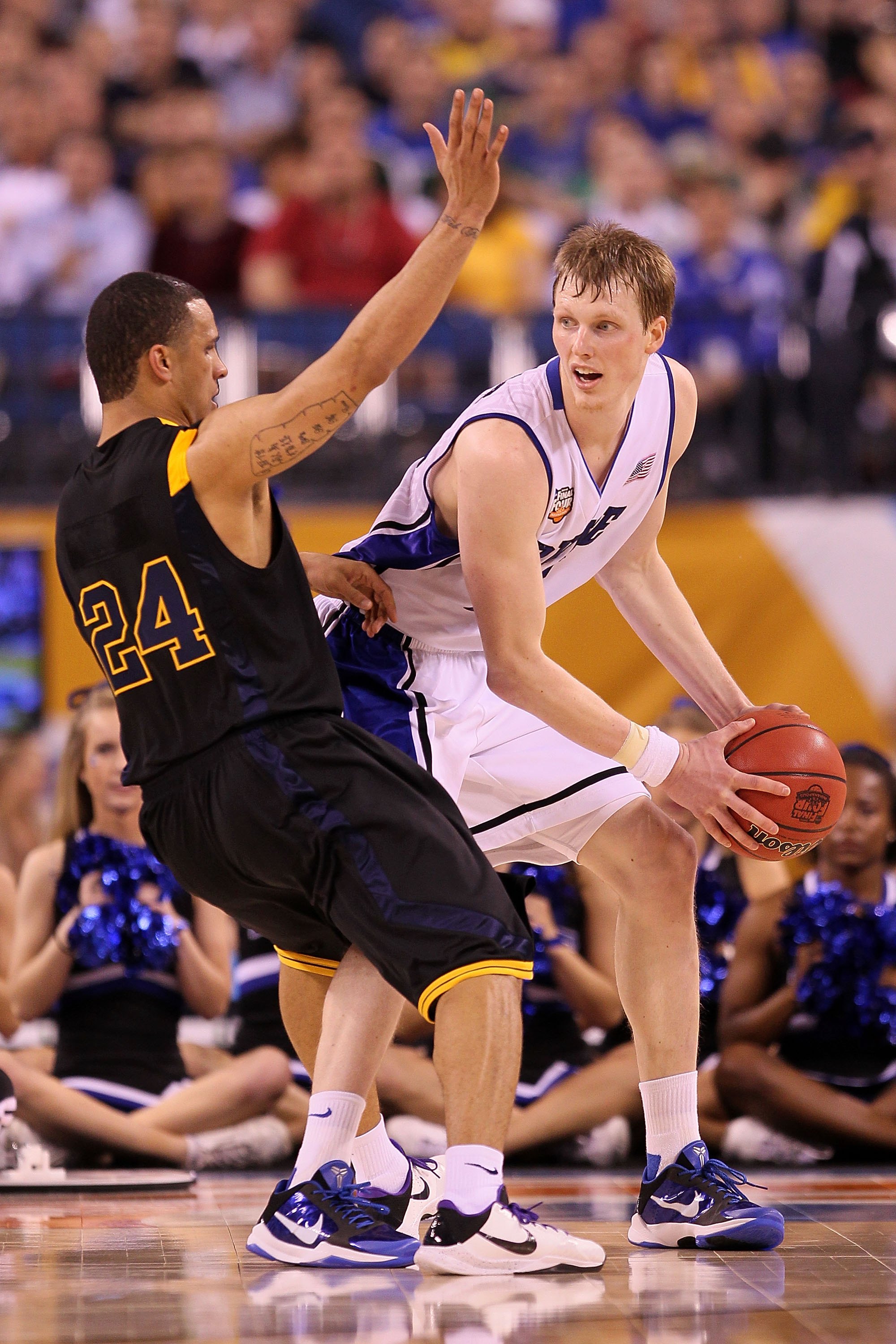 INDIANAPOLIS - APRIL 03:  Kyle Singler #15 of the Duke Blue Devils with the ball against Joe Mazzulla #24 of the West Virginia Mountaineers during the National Semifinal game of the 2010 NCAA Division I Men's Basketball Championship at Lucas Oil Stadium o