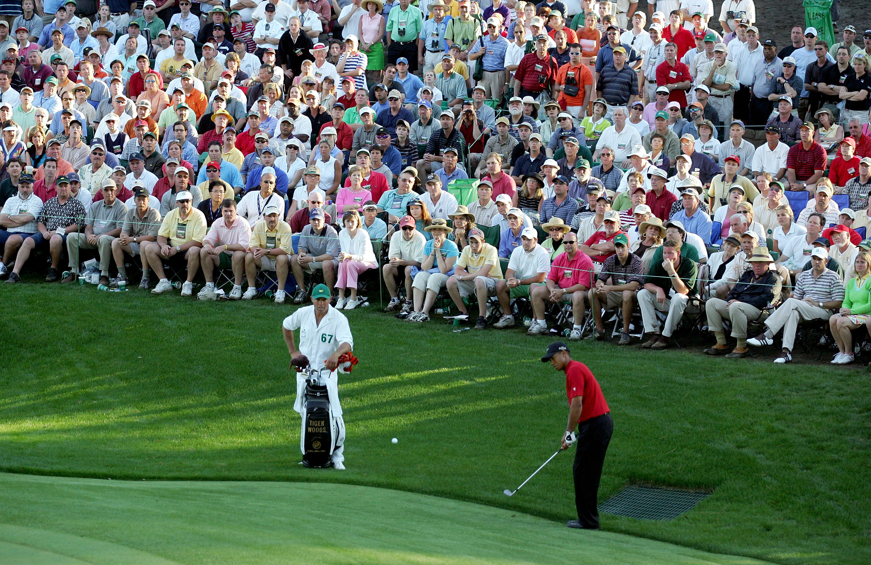 AUGUSTA, GA - APRIL 10:  Tiger Woods chips a shot to the 16th green for birdie as his caddie, Steve Williams, looks on during the final round of The Masters at the Augusta National Golf Club on April 10, 2005 in Augusta, Georgia.  (Photo by Harry How/Gett