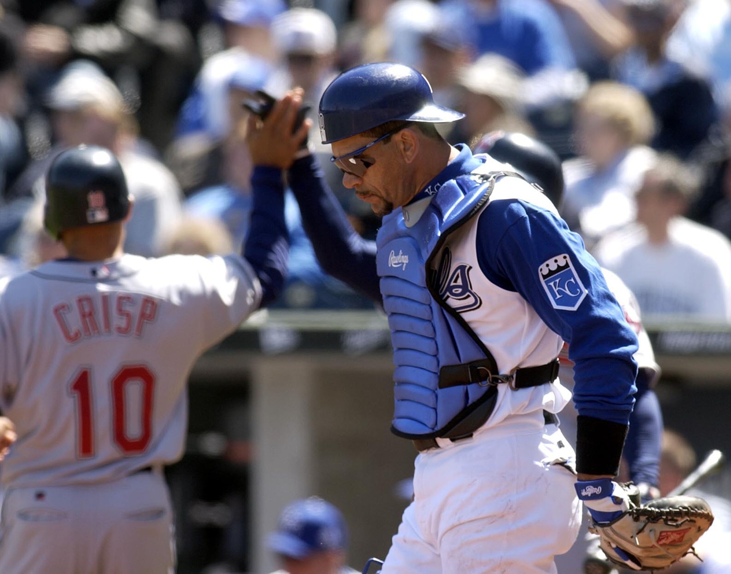 KANSAS CITY, MO - APRIL 8:  Benito Santiago #30 of the Kansas City Royals looks down at the ground as Coco Crisp #10 of the Cleveland Indians heads to the dugout after he scored on a Tim Laker hit in the second inning April 8, 2004 at Kauffman Stadium in 