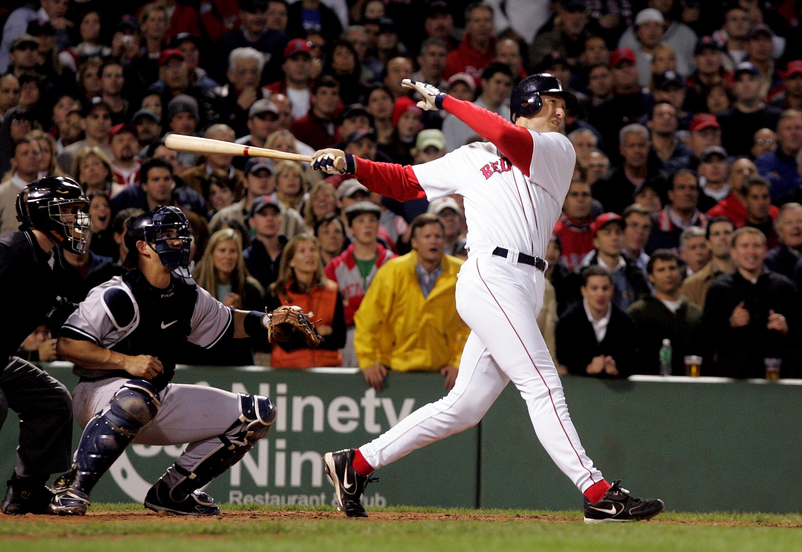 BOSTON - SEPTEMBER 30:  John Olerud #19 of the Boston Red Sox hits a sacrifice fly ball to score Manny Ramirez #24 in the sixth inning making it 5-1 against the New York Yankees during the game at Fenway Park on September 30, 2005 in Boston, Massachusetts
