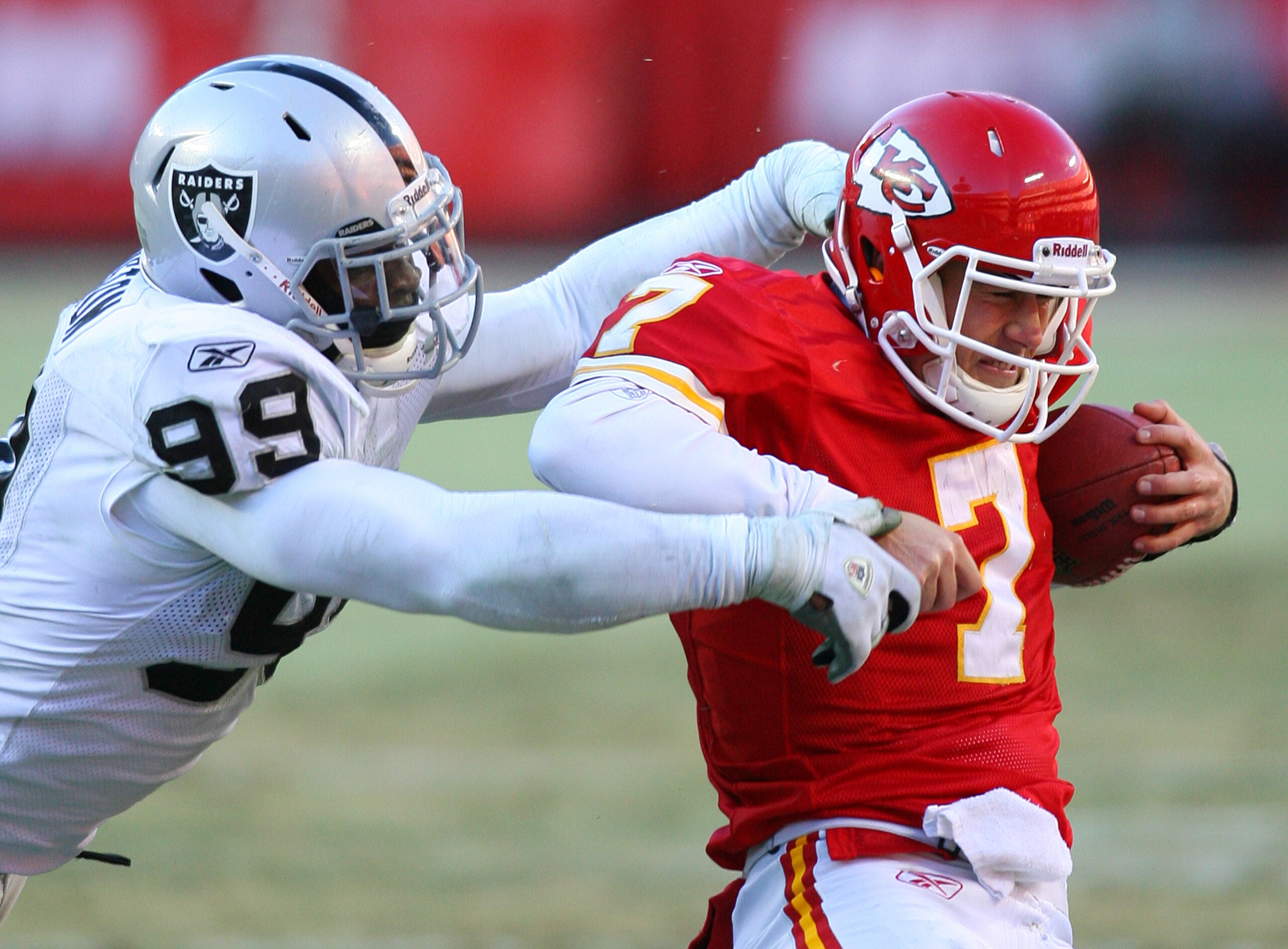 KANSAS CITY, MO - JANUARY 02:  Quarterback Matt Cassel #7 of the Kansas City Chiefs is sacked by defensive end Lamarr Houston #99 of the Oakland Raiders in a game at Arrowhead Stadium on January 2, 2011 in Kansas City, Missouri.  The Raiders won 31-10 (Ph