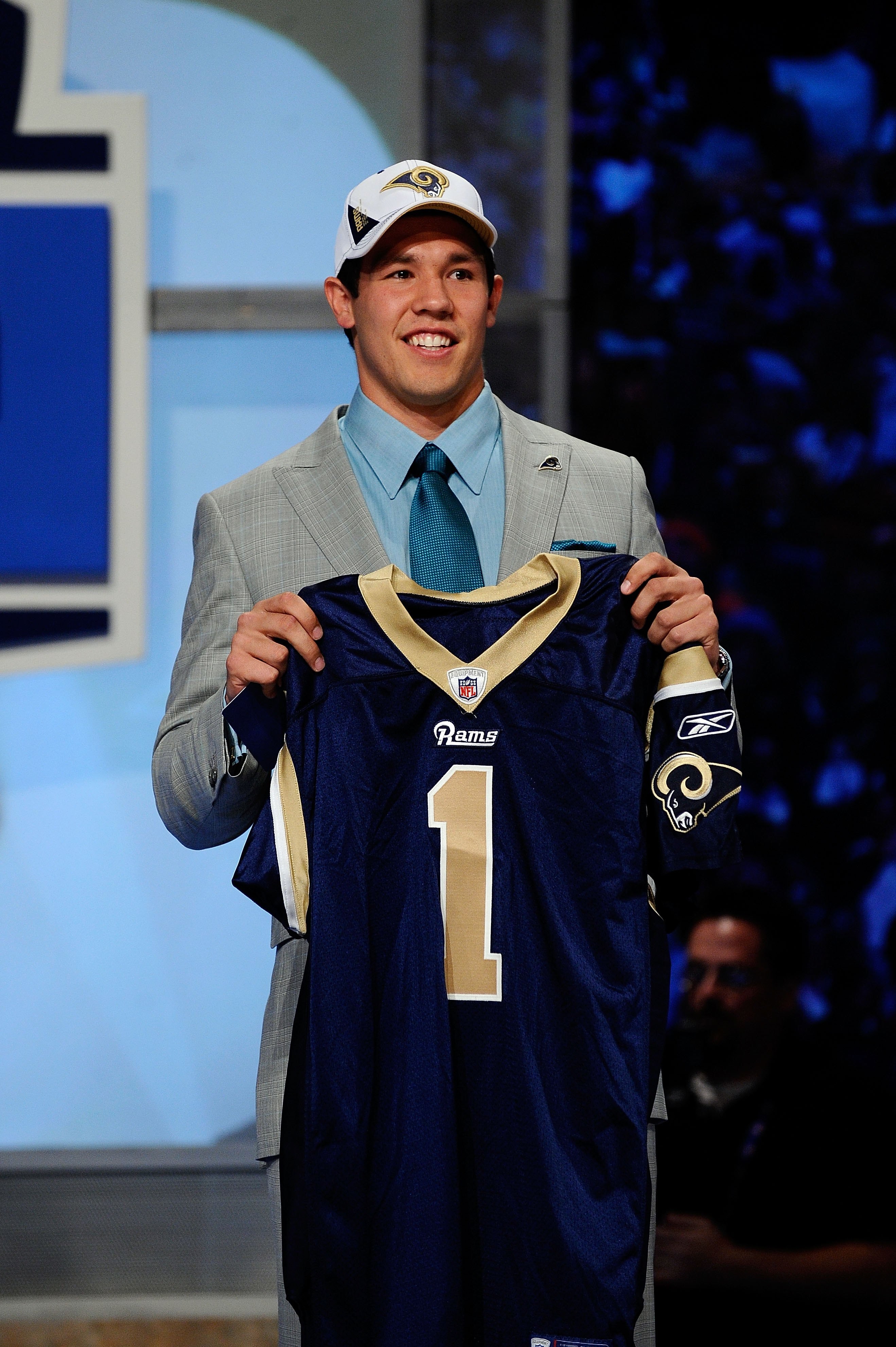 NEW YORK - APRIL 22:  Quarterback Sam Bradford from the Oklahoma Sooners holds up a St. Louis Rams jersey after the Rams selected Bradford numer 1 overall during the first round of the 2010 NFL Draft at Radio City Music Hall on April 22, 2010 in New York