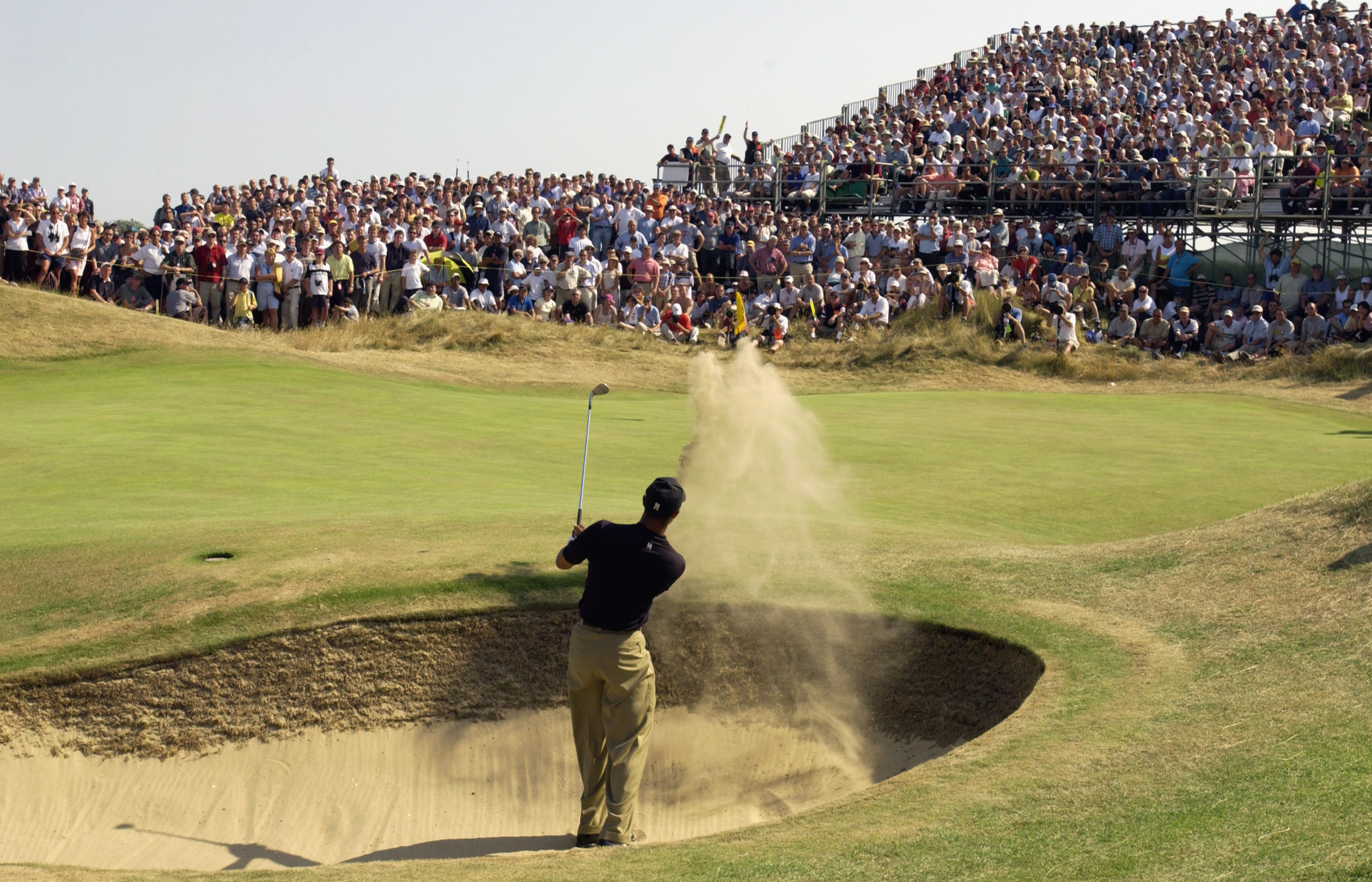 SANDWICH, ENGLAND - JULY 19: Tiger Woods of the USA plays out of the bunker on the sixth hole during the third round of The Open Championship on July 19, 2003 at the Royal St George's course in Sandwich, England. (Photo by Harry How/Getty Images)