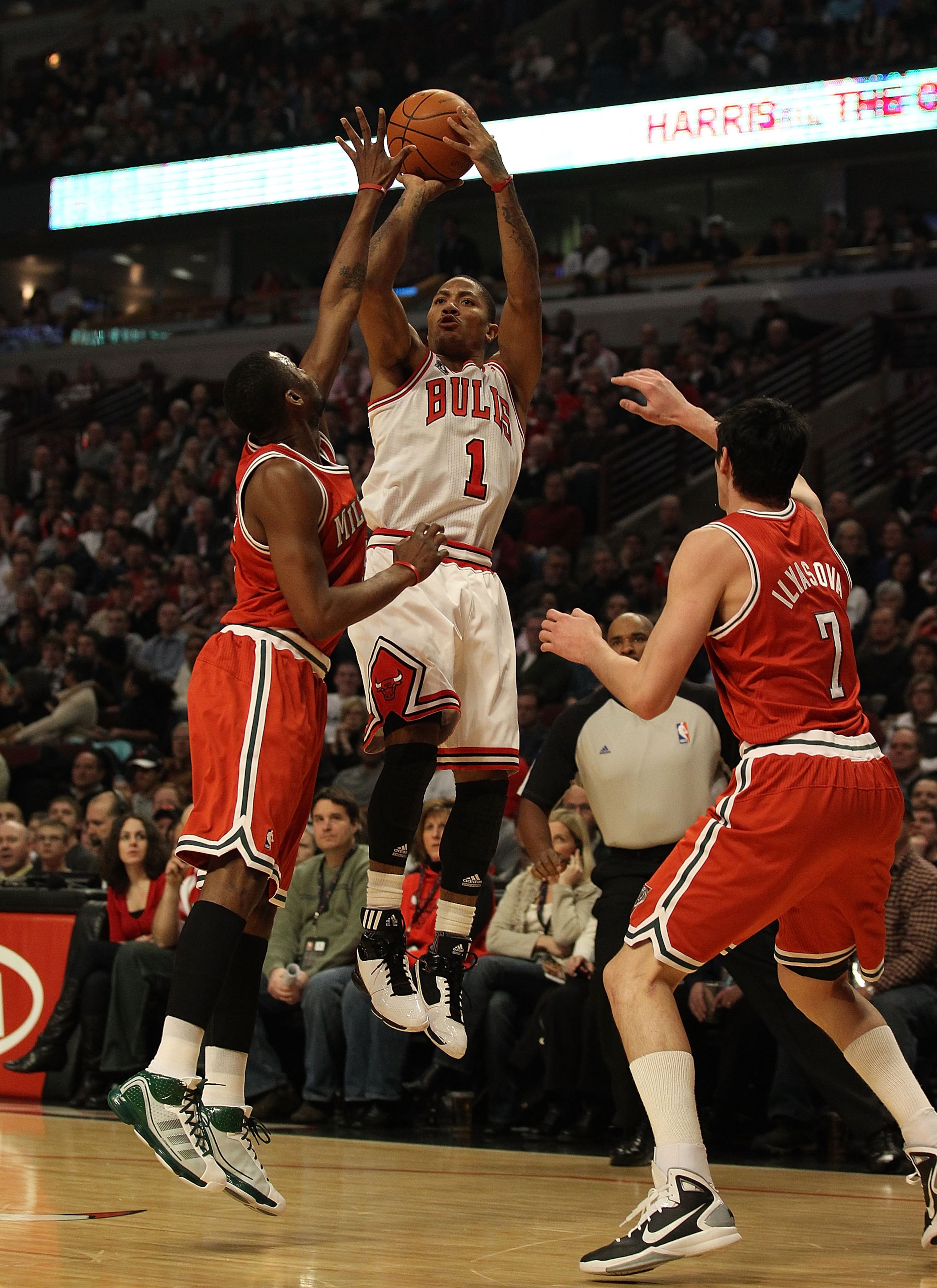 CHICAGO, IL - DECEMBER 28: Derrick Rose #1 of the Chicago Bulls puts up a shot against Keyon Dooling #55 and Ersan Ilyasova #7 of the Milwaukee Bucks at the United Center on December 28, 2010 in Chicago, Illinois. The Bulls defeated the Bucks 90-77. NOTE 