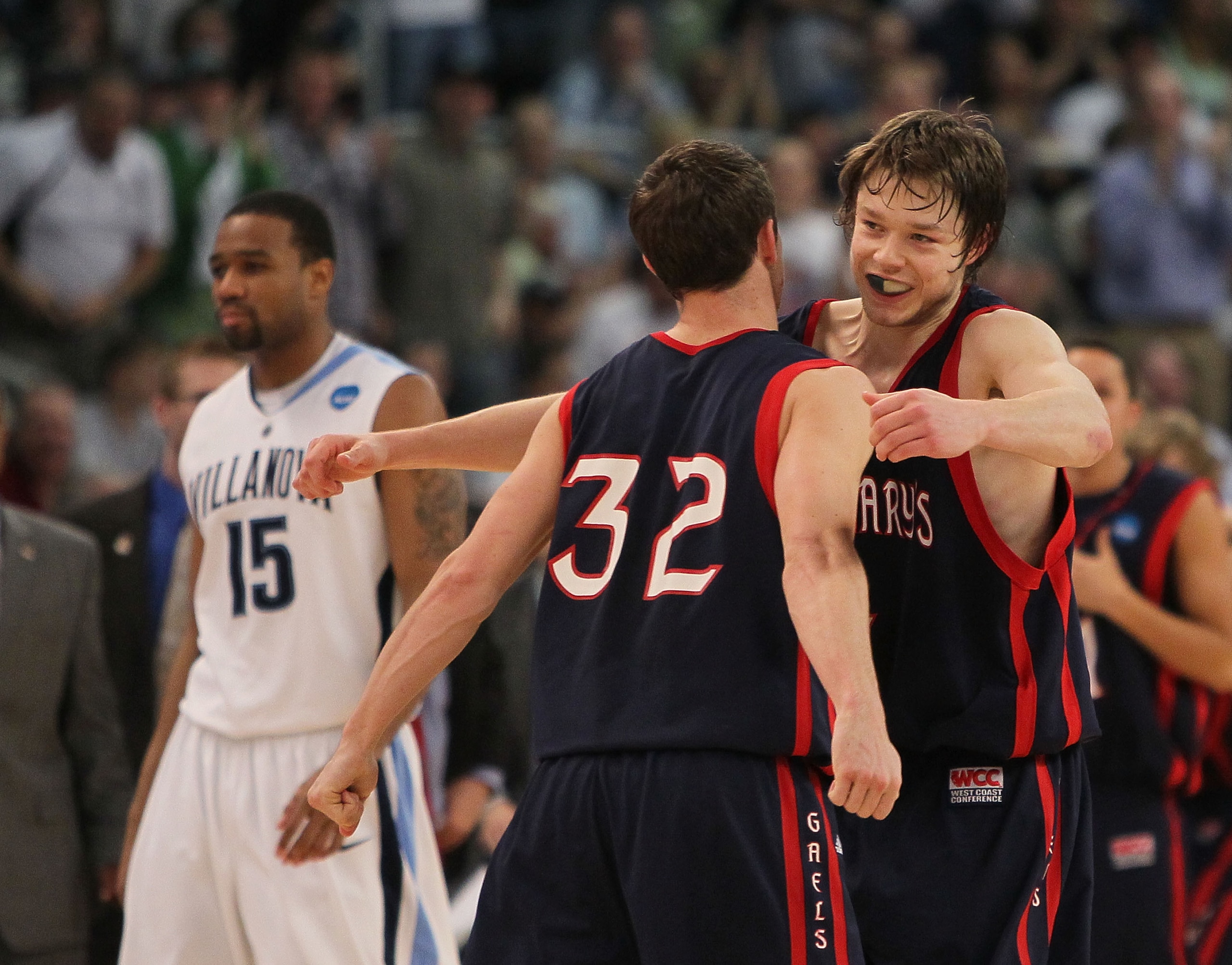 PROVIDENCE, RI - MARCH 20:  Mickey McConnell #32 is hugged by Matthew Dellavedova #4 of the Saint Mary's Gaels after a win as Reggie Redding #15 of the Villanova Wildcats leaves the court during the second round of the 2010 NCAA men's tournament at Dunkin