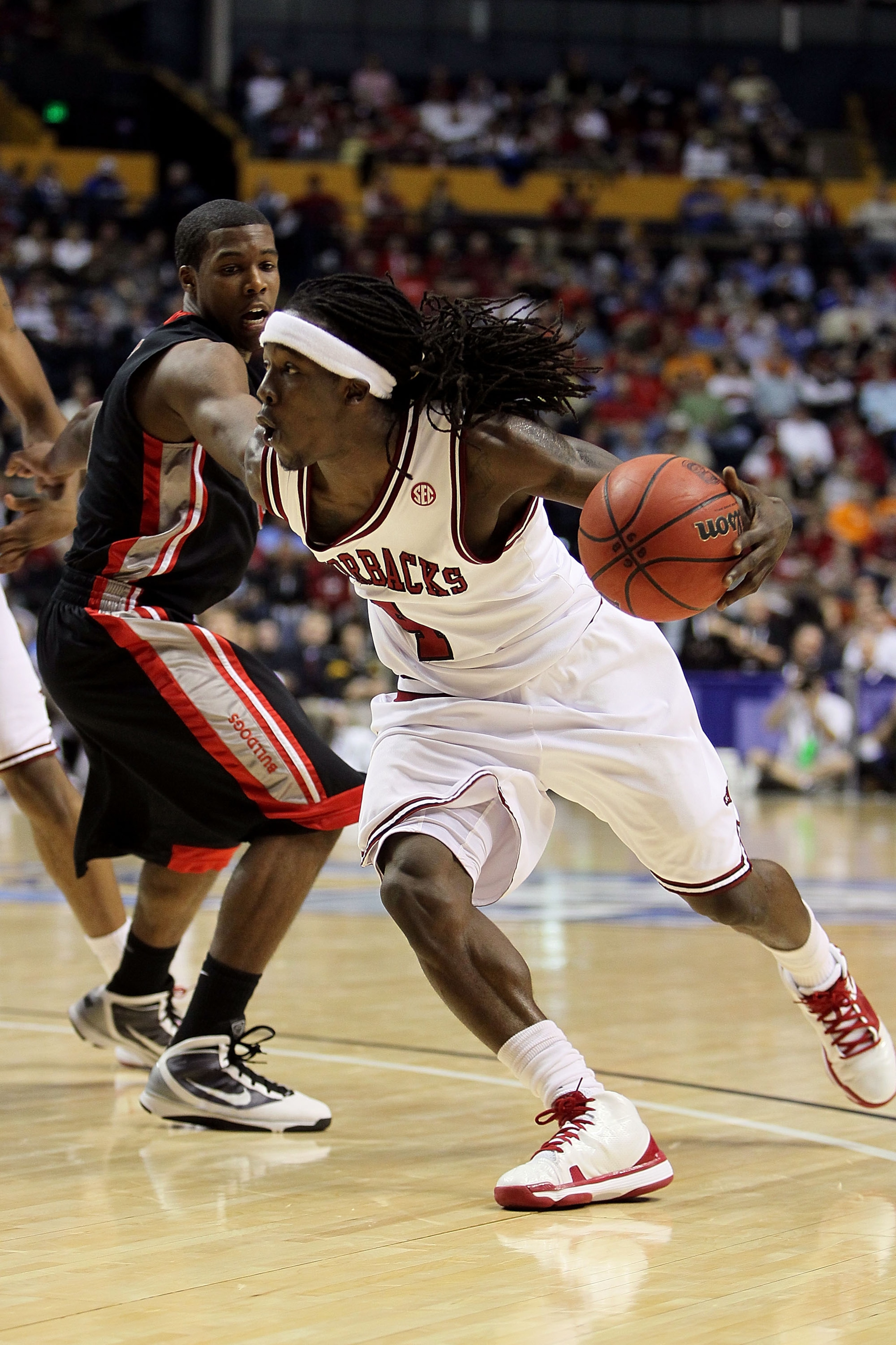 NASHVILLE, TN - MARCH 11: Courtney Fortson #4 of the Arkanasas Razorbacks drives against the Georgia Bulldogs during the first round of the SEC Men's Basketball Tournament at the Bridgestone Arena on March 11, 2010 in Nashville, Tennessee. (Photo by And NASHVILLE, TN - MARCH 11: Courtney Fortson #4 of the Arkanasas Razorbacks drives against the Georgia Bulldogs during the first round of the SEC Men's Basketball Tournament at the Bridgestone Arena on March 11, 2010 in Nashville, Tennessee. (Photo by And