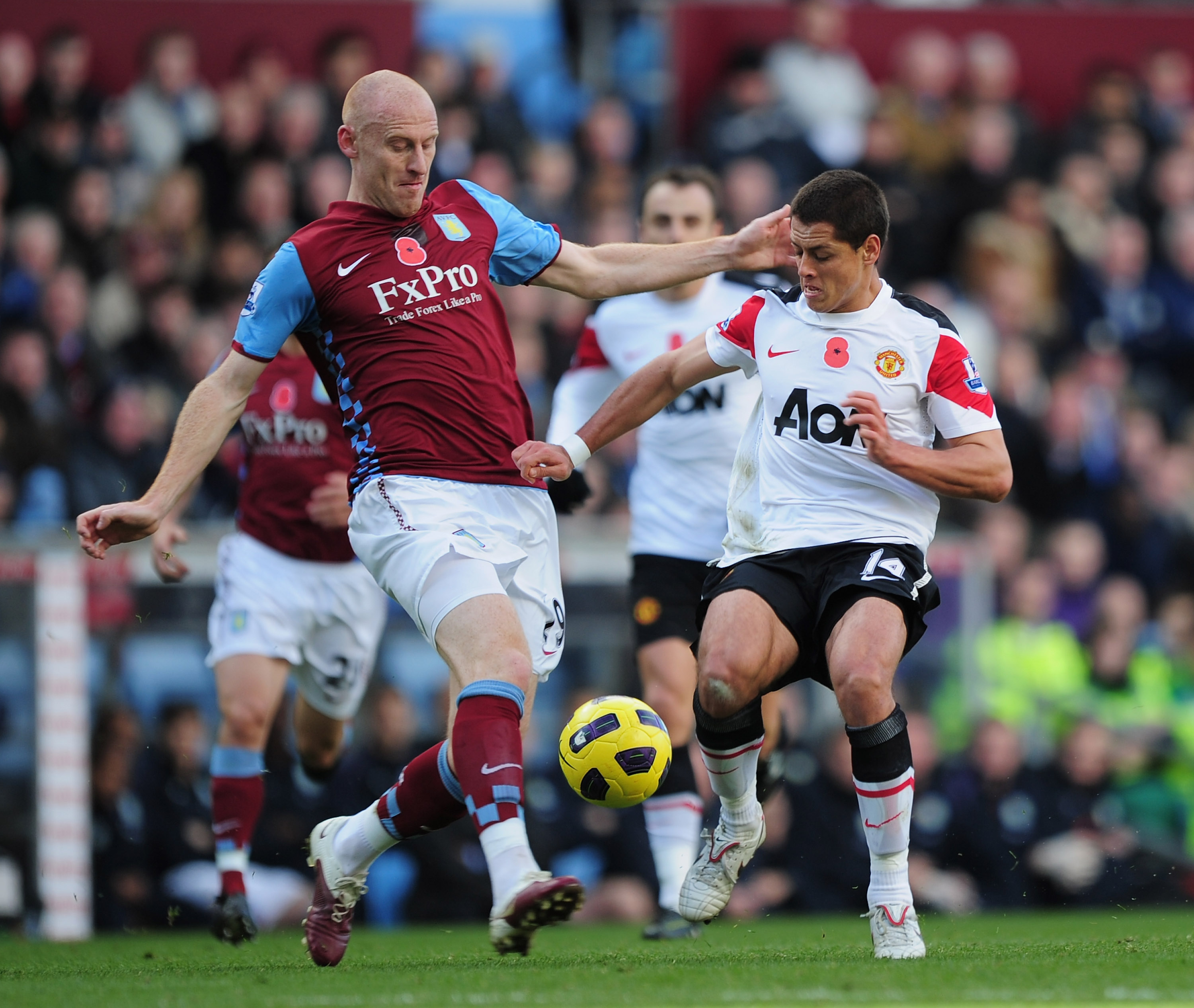 BIRMINGHAM, ENGLAND - NOVEMBER 13:  Javier Hernandez of Manchester United is challenged by James Collins of Aston Villa during the Barclays Premier League match between Aston Villa and Manchester United at Villa Park on November 13, 2010 in Birmingham, En