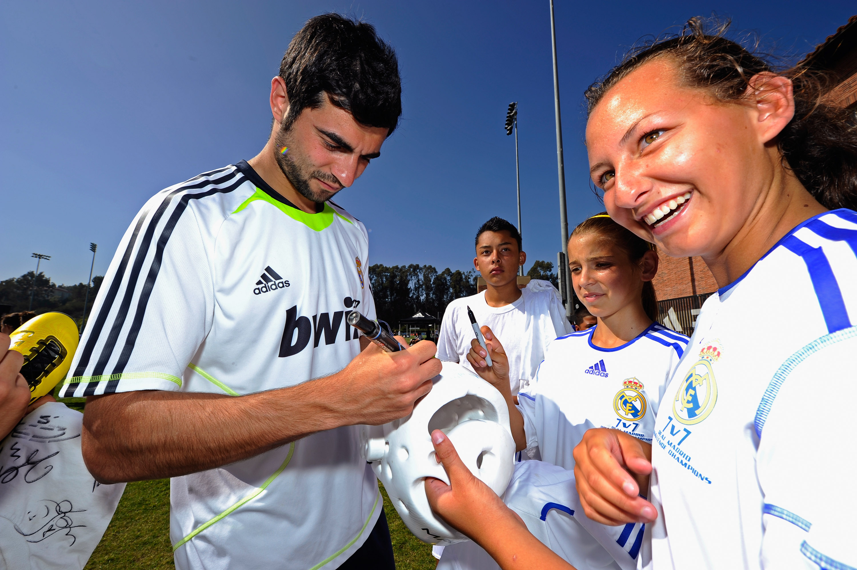 LOS ANGELES, CA - AUGUST 05:  Raul Albiol #18 of Real Madrid signs a soccer shirt for a local youth soccer player after participating in the Adidas training August 5, 2010 in Westwood section of Los Angeles, California. (Photo by Kevork Djansezian/Getty I