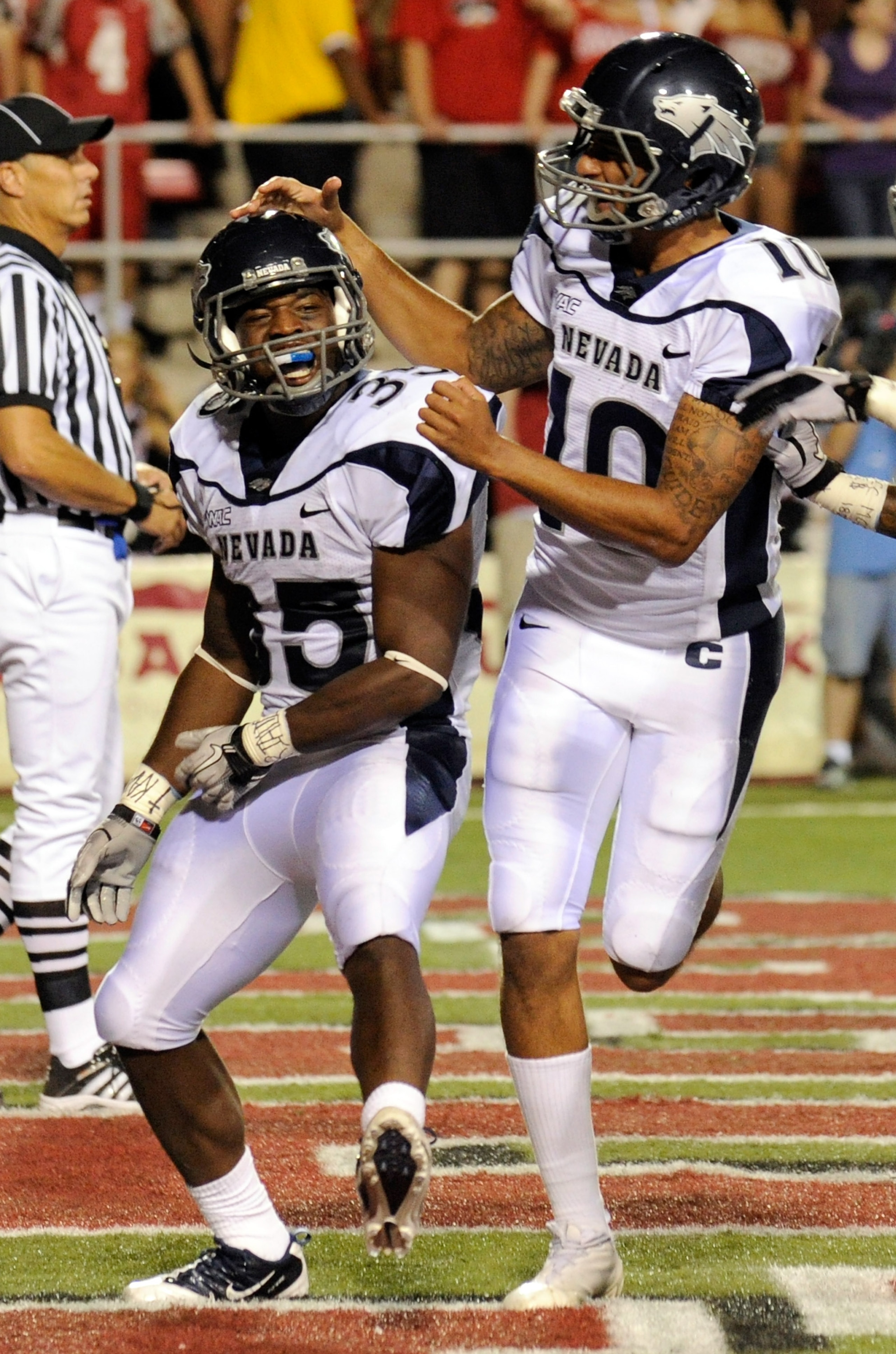LAS VEGAS - OCTOBER 02:  Courtney Randall #35 of the Nevada Reno Wolf Pack is congratulated by quarterback Colin Kaepernick #10 after Randall scored a touchdown against the UNLV Rebels in the second quarter of their game at Sam Boyd Stadium October 2, 201