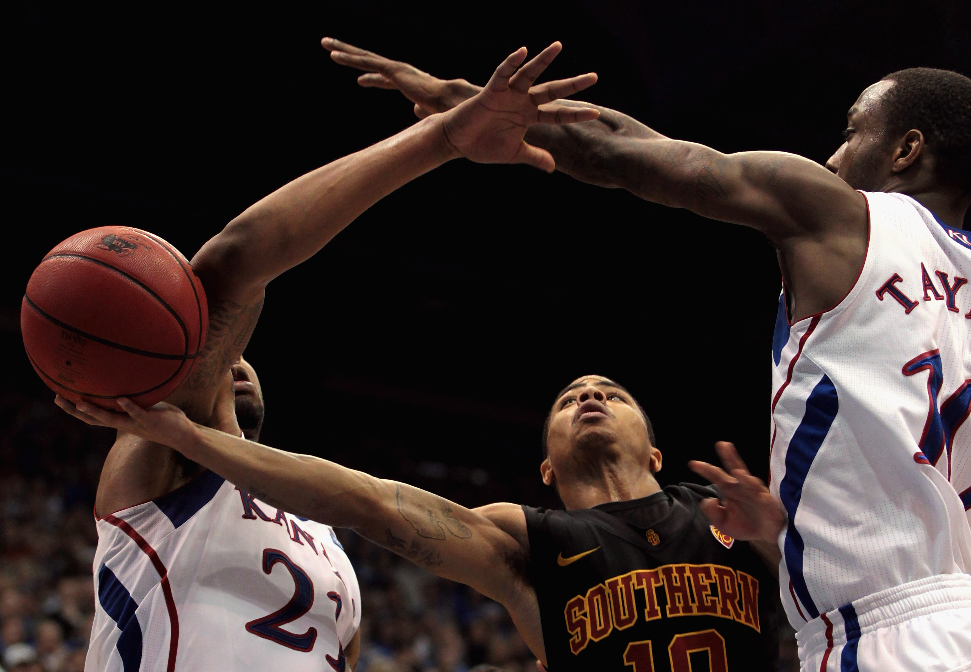 LAWRENCE, KS - DECEMBER 18:  Maurice Jones #10 of the USC Trojans shoots as Markieff Morris #21 and Tyshawn Taylor #10 of the Kansas Jayhawks defend during the game on December 18, 2010 at Allen Fieldhouse in Lawrence, Kansas.  (Photo by Jamie Squire/Gett