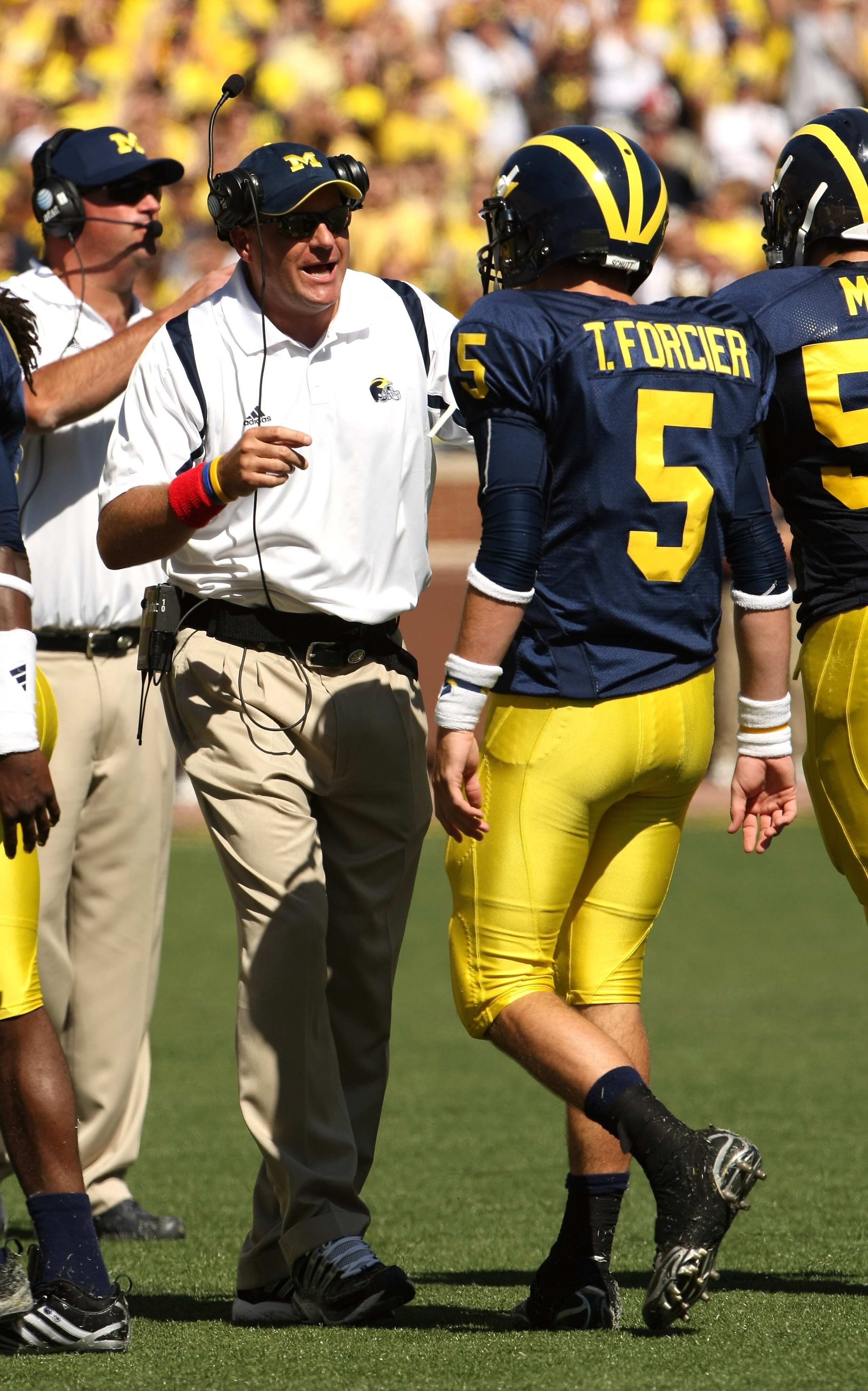 ANN ARBOR, MI - SEPTEMBER 19: Head coach Rich Rodriguez of the Michigan Wolverines talks with quarterback Tate Forcier #5 during the game with the Eastern Michigan Eagles at Michigan Stadium on September 19, 2009 in Ann Arbor, Michigan. (Photo by Stephe ANN ARBOR, MI - SEPTEMBER 19: Head coach Rich Rodriguez of the Michigan Wolverines talks with quarterback Tate Forcier #5 during the game with the Eastern Michigan Eagles at Michigan Stadium on September 19, 2009 in Ann Arbor, Michigan. (Photo by Stephe