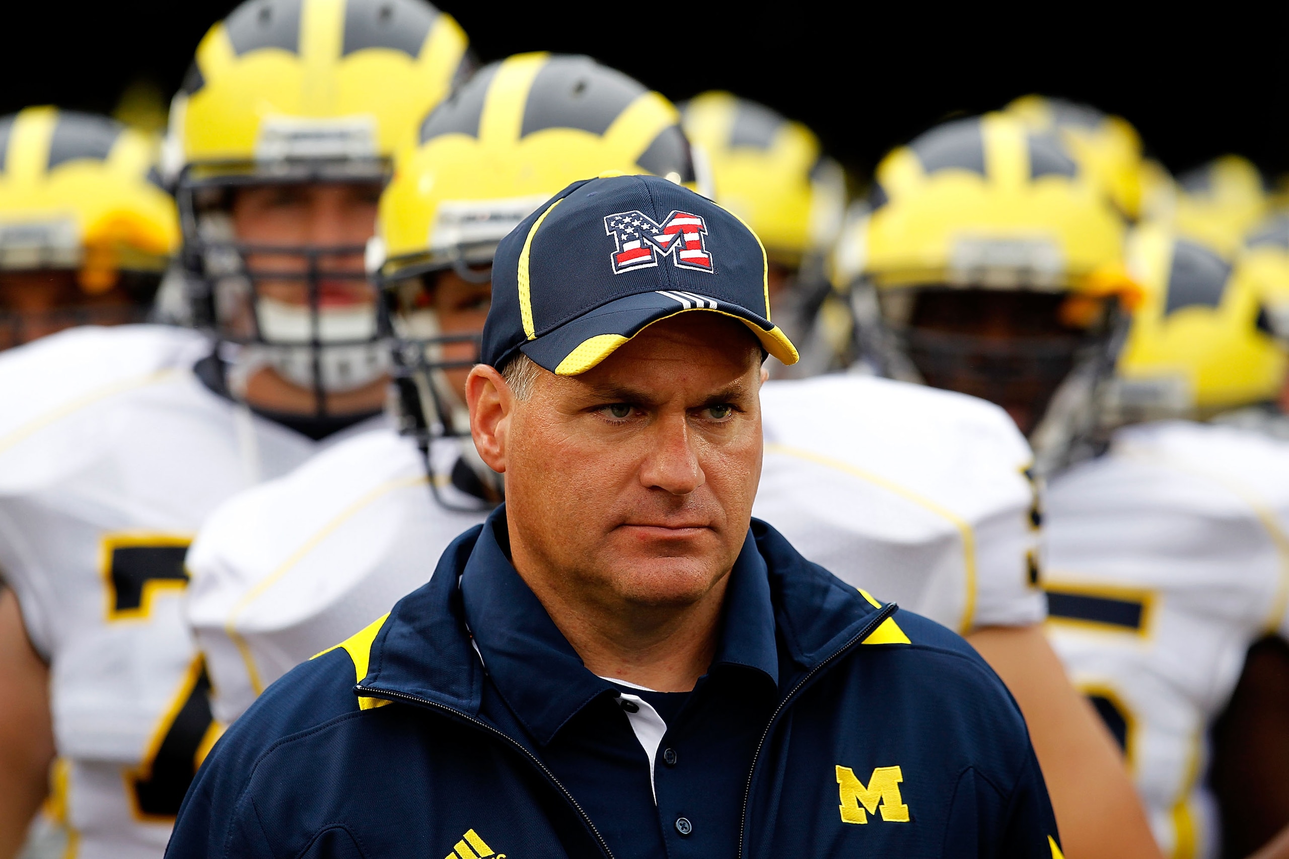 SOUTH BEND, IN - SEPTEMBER 11: Head coach Rich Rodriguez of the Michigan Wolverines waits with his team before entering the field for a game against the Notre Dame Fighting Irish at Notre Dame Stadium on September 11, 2010 in South Bend, Indiana. Michigan SOUTH BEND, IN - SEPTEMBER 11: Head coach Rich Rodriguez of the Michigan Wolverines waits with his team before entering the field for a game against the Notre Dame Fighting Irish at Notre Dame Stadium on September 11, 2010 in South Bend, Indiana. Michigan