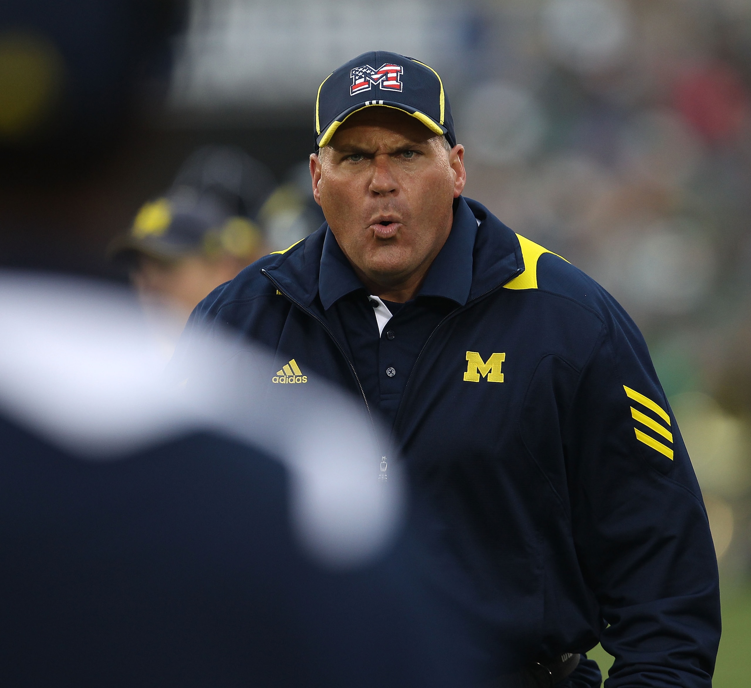 SOUTH BEND, IN - SEPTEMBER 11: Head coach Rich Rodriguez of the Michigan Wolverines yells at an assistant coach during a game against the Notre Dame Fighting Irish at Notre Dame Stadium on September 11, 2010 in South Bend, Indiana. Michigan defeated Notre SOUTH BEND, IN - SEPTEMBER 11: Head coach Rich Rodriguez of the Michigan Wolverines yells at an assistant coach during a game against the Notre Dame Fighting Irish at Notre Dame Stadium on September 11, 2010 in South Bend, Indiana. Michigan defeated Notre