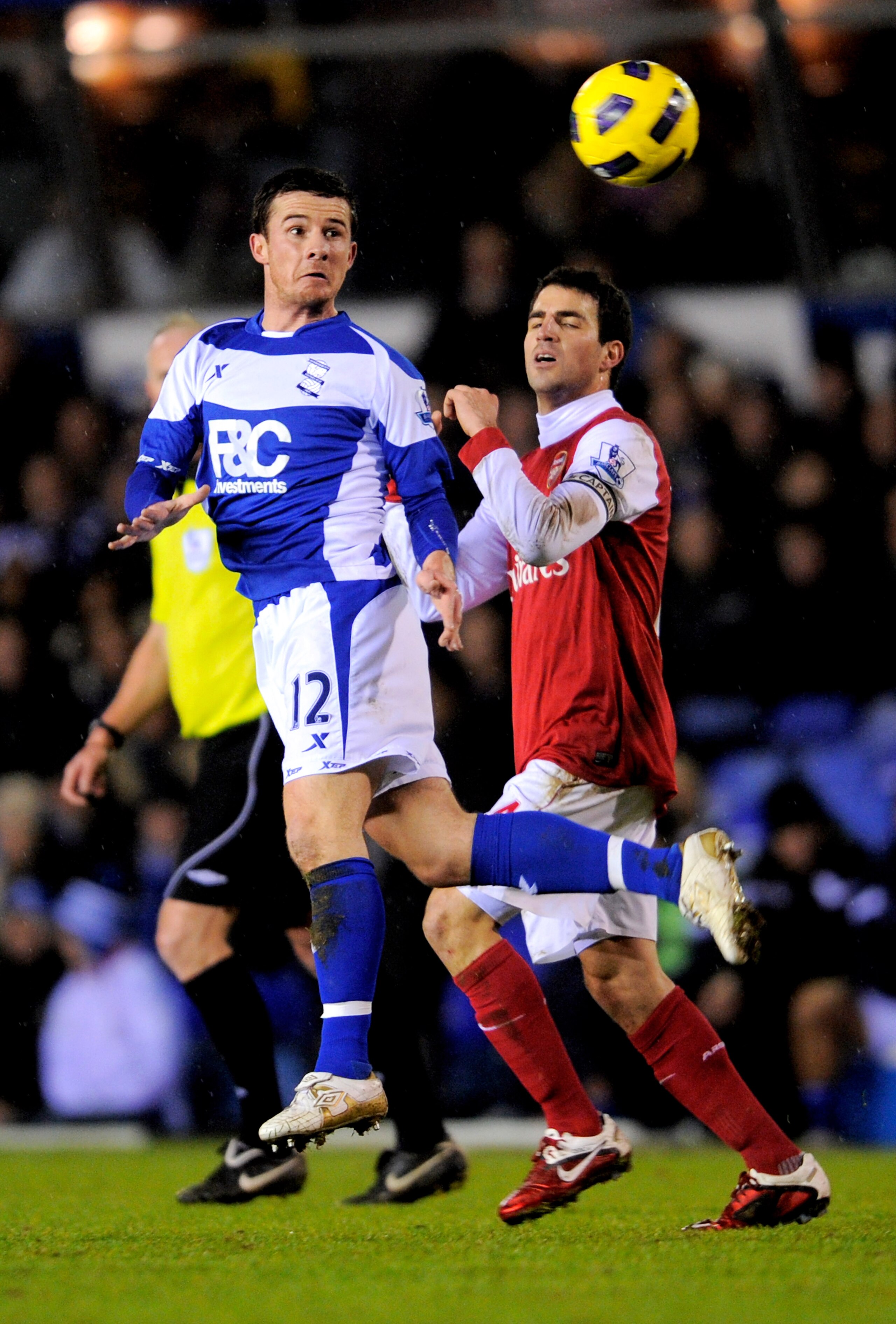 BIRMINGHAM, ENGLAND - JANUARY 01:  Barry Ferguson of Birmingham heads the ball under pressure from Cesc Fabregas of Arsenal during the Barclays Premier Leaue match between Birmingham City and Arsenal at St. Andrews on January 1, 2011 in Birmingham, Englan