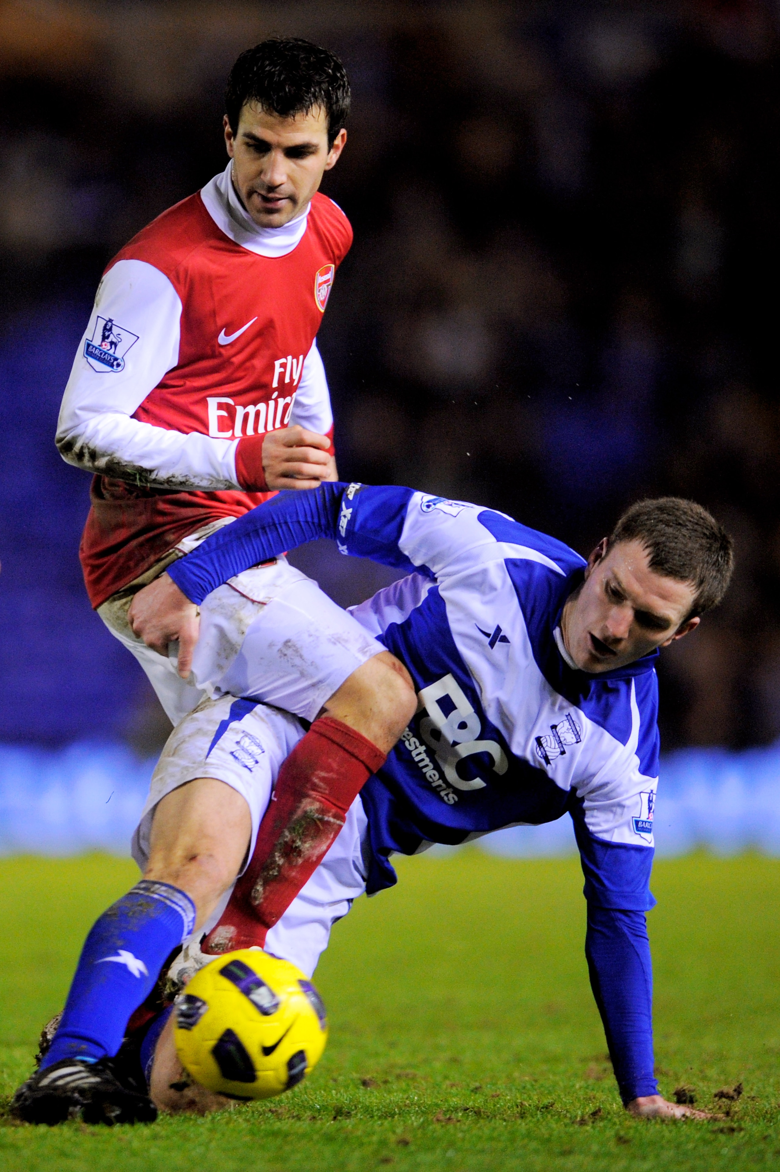 BIRMINGHAM, ENGLAND - JANUARY 01:  Cesc Fabregas of Arsenal is tackled by Craig Gardner of Birmingham during the Barclays Premier Leaue match between Birmingham City and Arsenal at St. Andrews on January 1, 2011 in Birmingham, England.  (Photo by Michael