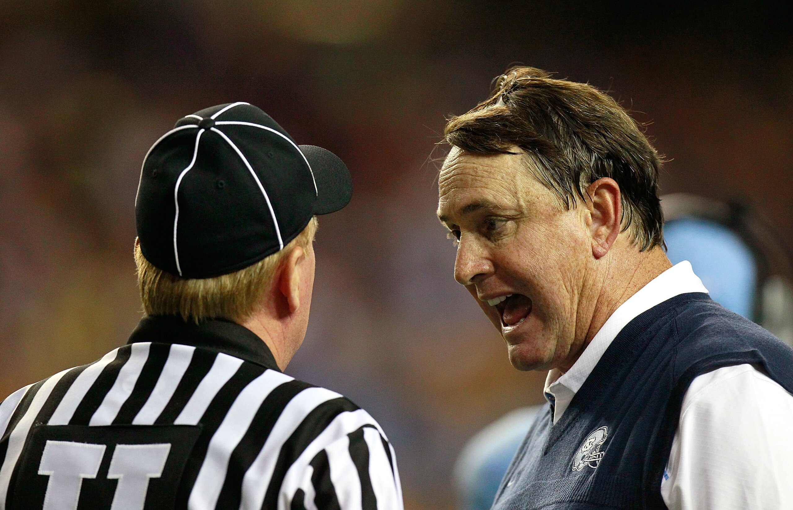 ATLANTA - SEPTEMBER 04:  Head coach Butch Davis of the North Carolina Tar Heels and Umpire Brent Sowell during the game against the LSU Tigers in the Chick-fil-A Kickoff Game at Georgia Dome on September 4, 2010 in Atlanta, Georgia.  (Photo by Kevin C. Co