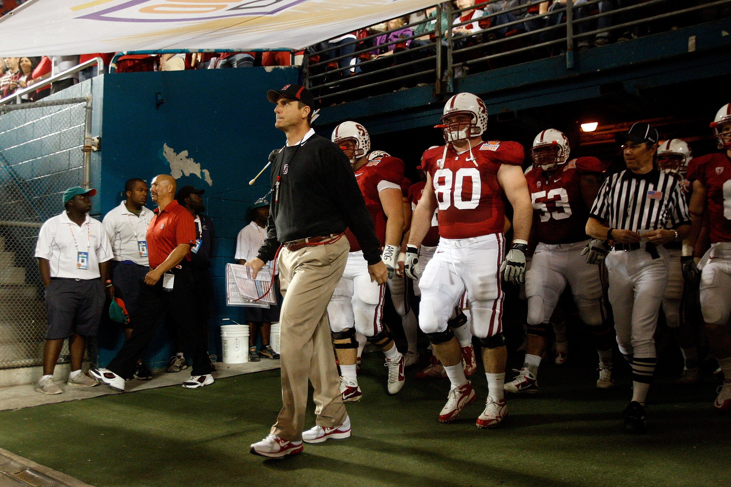MIAMI, FL - JANUARY 03:  Head coach Jim Harbaugh of the Stanford Cardinal walks out of the tunnel to lead his team onto the field and play against the Virginia Tech Hokies during the 2011 Discover Orange Bowl at Sun Life Stadium on January 3, 2011 in Miam
