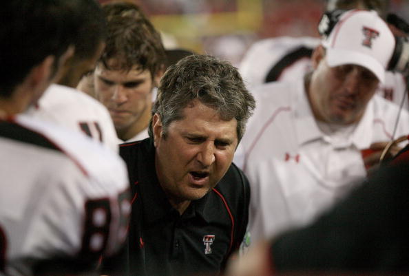 HOUSTON - SEPTEMBER 26: Head coach Mike Leach of the Texas Tech Red Raiders talks with his defense while playing against the University of Houston at Robertson Stadium on September 26, 2009 in Houston, Texas.  (Photo by Thomas B. Shea/Getty Images)