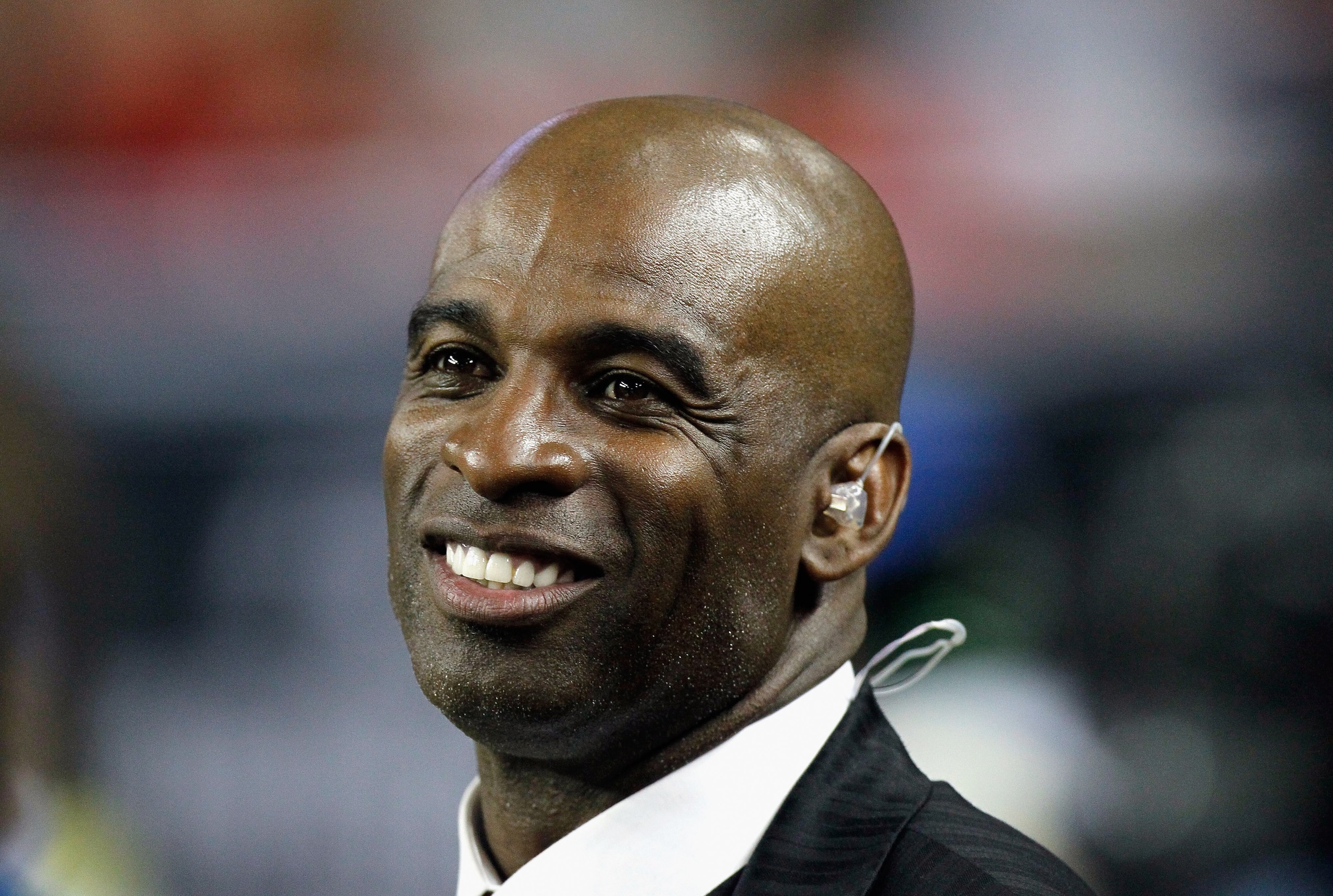 ATLANTA - NOVEMBER 11: NFL network broadcaster and former Atlanta Falcons player Deion Sanders watches from the sidelines after being inducted into the Falcons Ring of Honor during halftime of the game against the Baltimore Ravens at Georgia Dome on Nove ATLANTA - NOVEMBER 11: NFL network broadcaster and former Atlanta Falcons player Deion Sanders watches from the sidelines after being inducted into the Falcons Ring of Honor during halftime of the game against the Baltimore Ravens at Georgia Dome on Nove