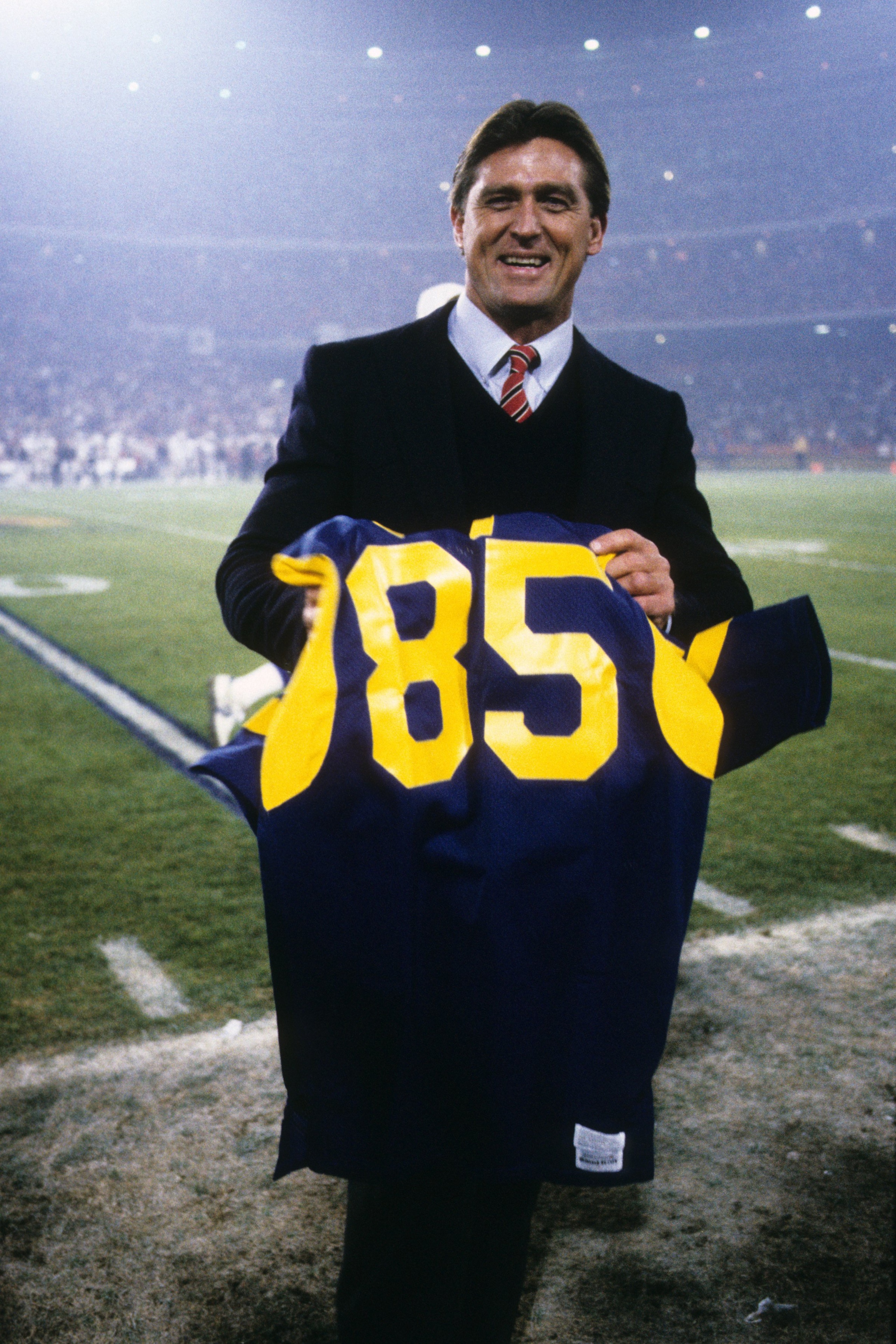 ANAHEIM, CA - DECEMBER 23: Former Los Angeles Rams great, Jack Youngblood, poses with his officially retired Rams jersey during the game against the Los Angeles Raiders at Anaheim Stadium on December 23, 1985 in Anaheim, California. The Raiders won 16-6. ANAHEIM, CA - DECEMBER 23: Former Los Angeles Rams great, Jack Youngblood, poses with his officially retired Rams jersey during the game against the Los Angeles Raiders at Anaheim Stadium on December 23, 1985 in Anaheim, California. The Raiders won 16-6.