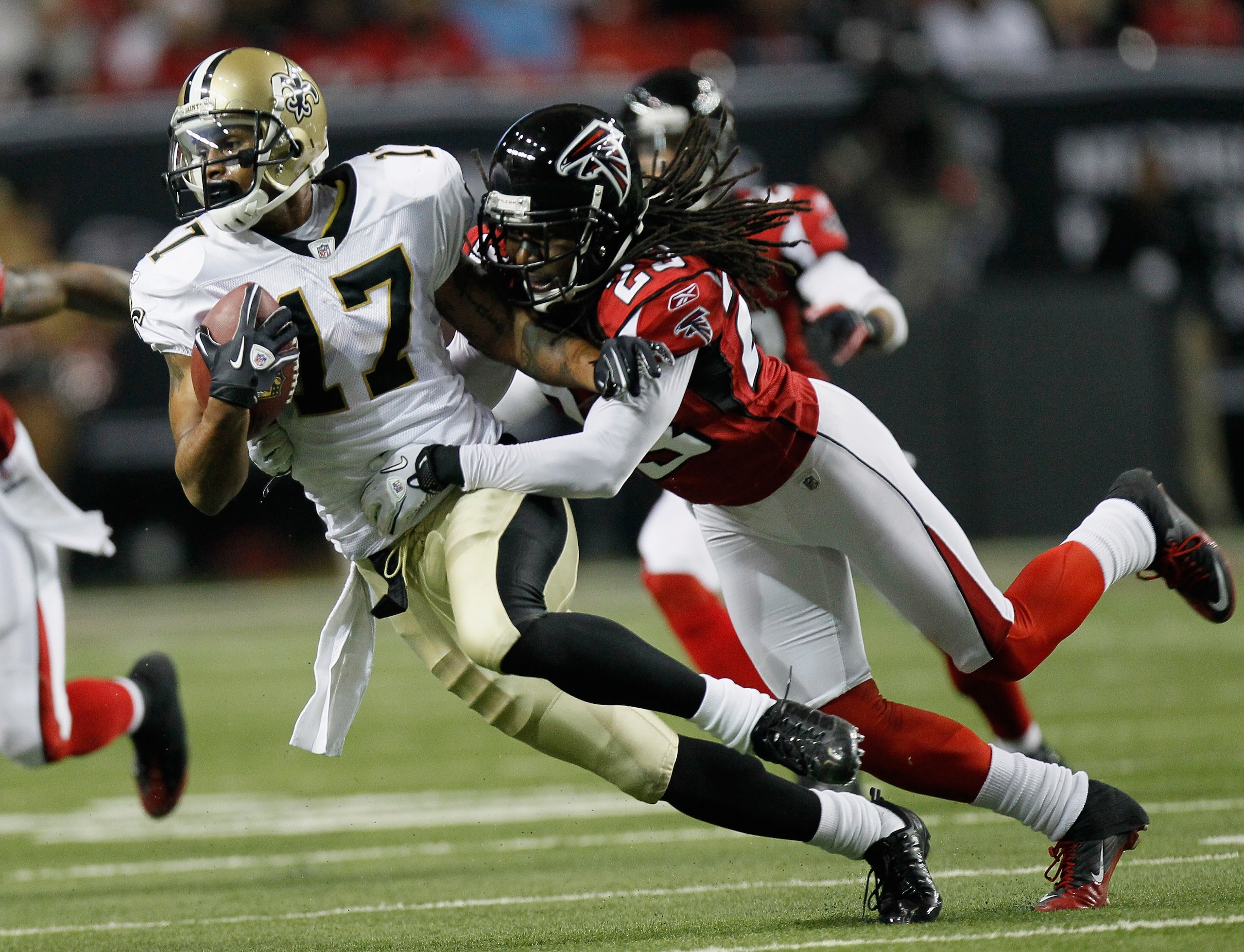 ATLANTA, GA - DECEMBER 27:  Robert Meachem #17 of the New Orleans Saints fights off the tackle of Atlanta Falcons defender Dunta Robinson #23  in the first half during their game at the Georgia Dome on December 27, 2010 in Atlanta, Georgia.  (Photo by Kev