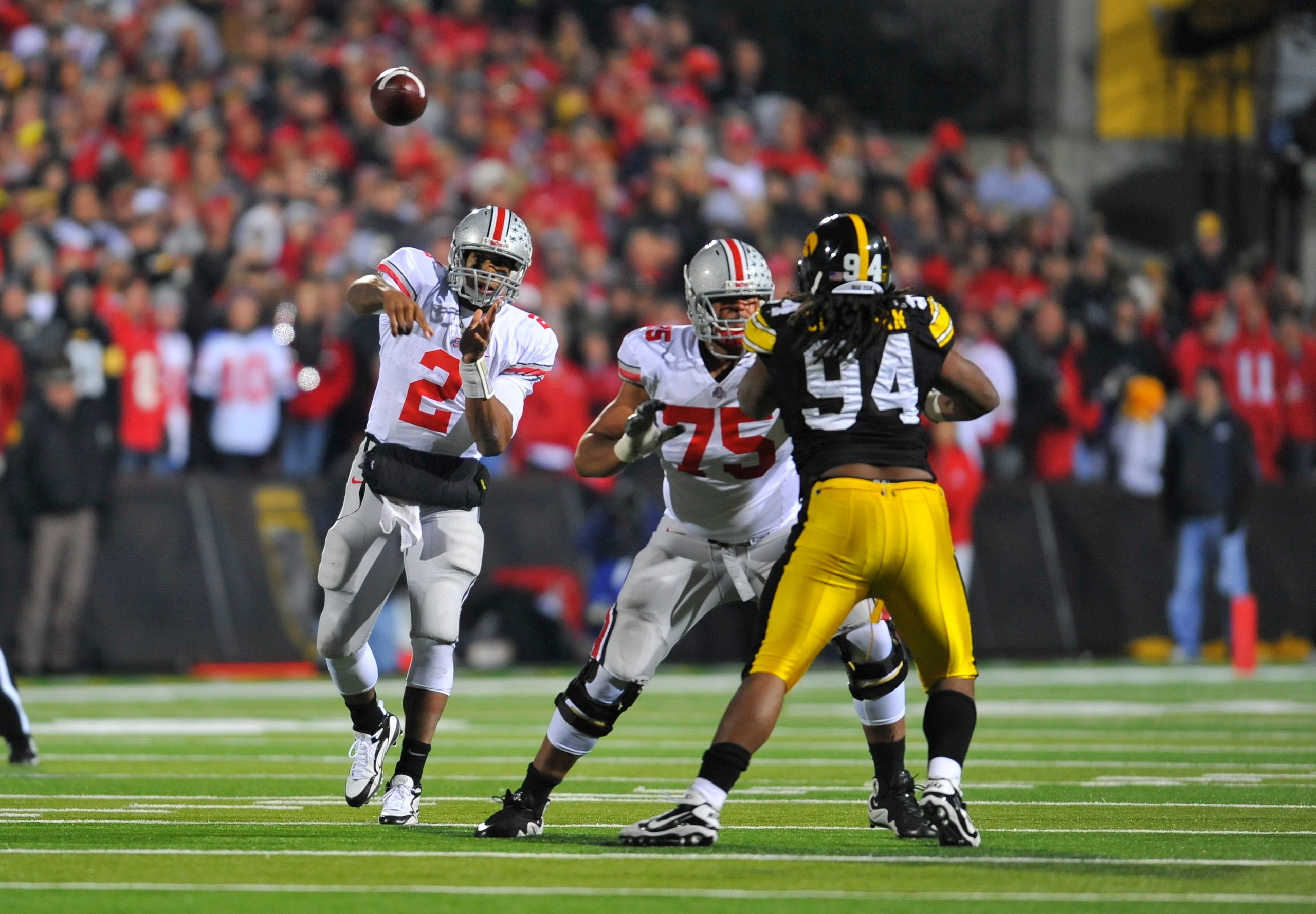 IOWA CITY, IA - NOVEMBER 20: Quarterback Terrelle Pryor #2 of the Ohio State Buckeyes throws under pressure from defensive end Adrian Clayborn #94 of the University of Iowa Hawkeyes as offensive lineman Mike Adams #75 defends during the second half of pl IOWA CITY, IA - NOVEMBER 20: Quarterback Terrelle Pryor #2 of the Ohio State Buckeyes throws under pressure from defensive end Adrian Clayborn #94 of the University of Iowa Hawkeyes as offensive lineman Mike Adams #75 defends during the second half of pl