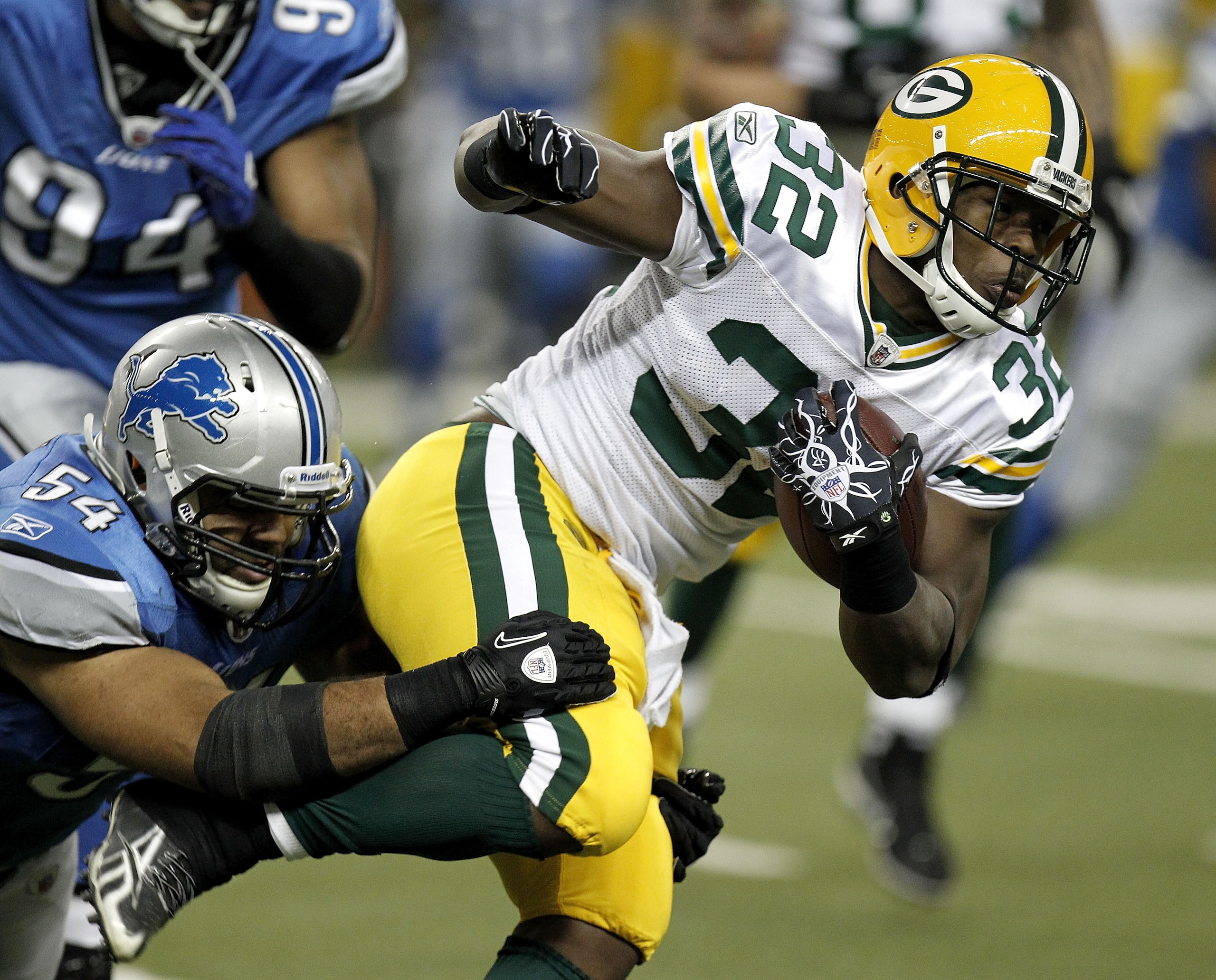 DETROIT, MI - DECEMBER 12: Brandon Jackson #32 of the Green Bay Packers tries to get past the tackle of DeAndre Levy #54 of the Detroit Lions on December 12, 2010 at Ford Field in Detroit, Michigan.  (Photo by Gregory Shamus/Getty Images)